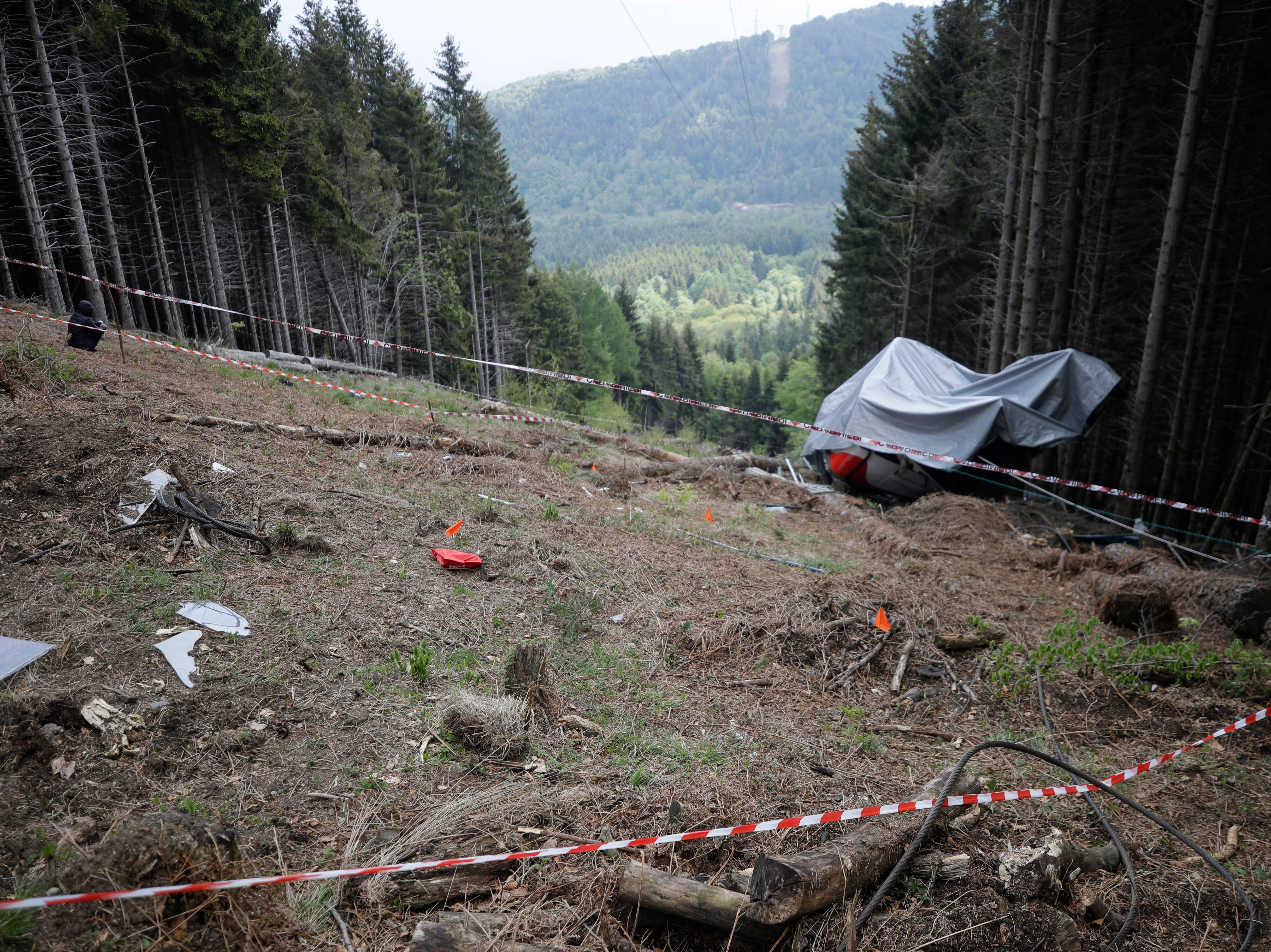 The wreckage of a cable car after it collapsed near the summit of the Stresa-Mottarone line in the Piedmont region, northern Italy