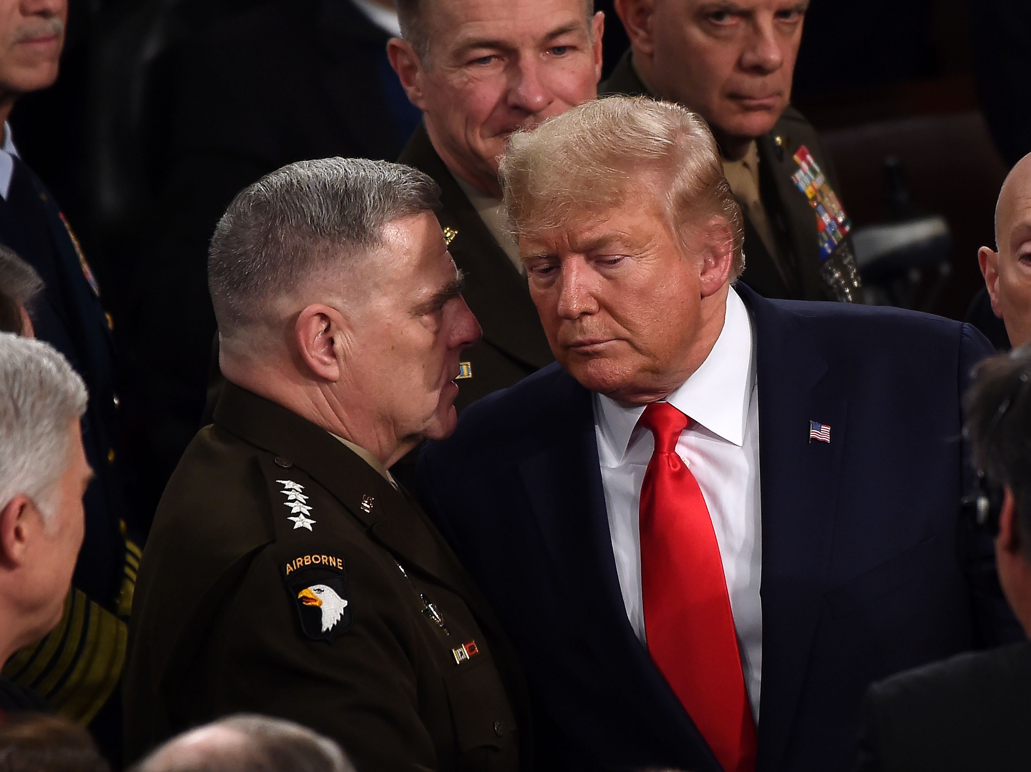 Chairman of the Joint Chiefs of Staff Gen. Mark Milley chats with US President Donald Trump after he delivered the State of the Union address at the US Capitol in Washington, DC, on February 4, 2020