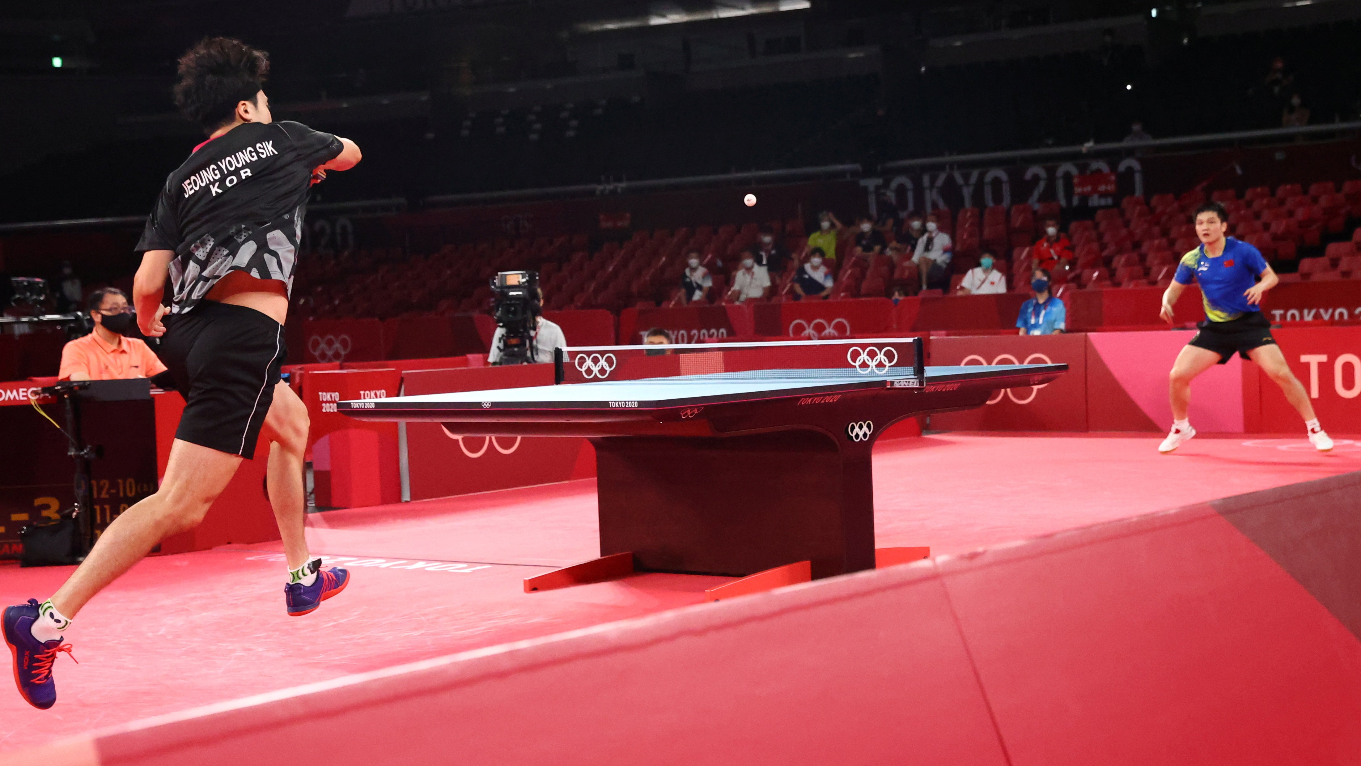 Jeoung Young-Sik of South Korea (left) in action against Fan Zhendong of China (right) at the Tokyo 2020 Olympics