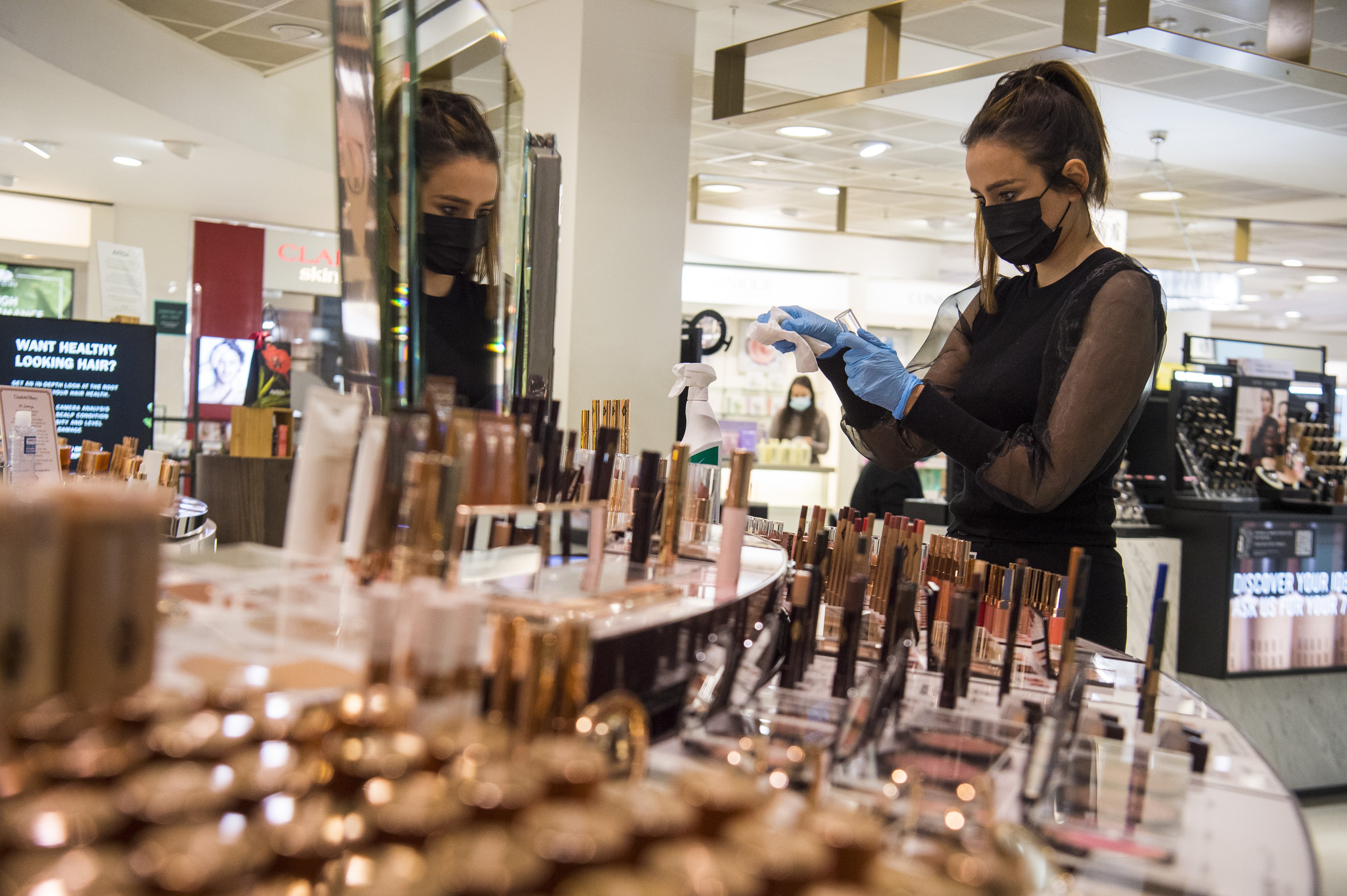 A John Lewis partner cleans a counter (Kirsty O’Connor/PA)