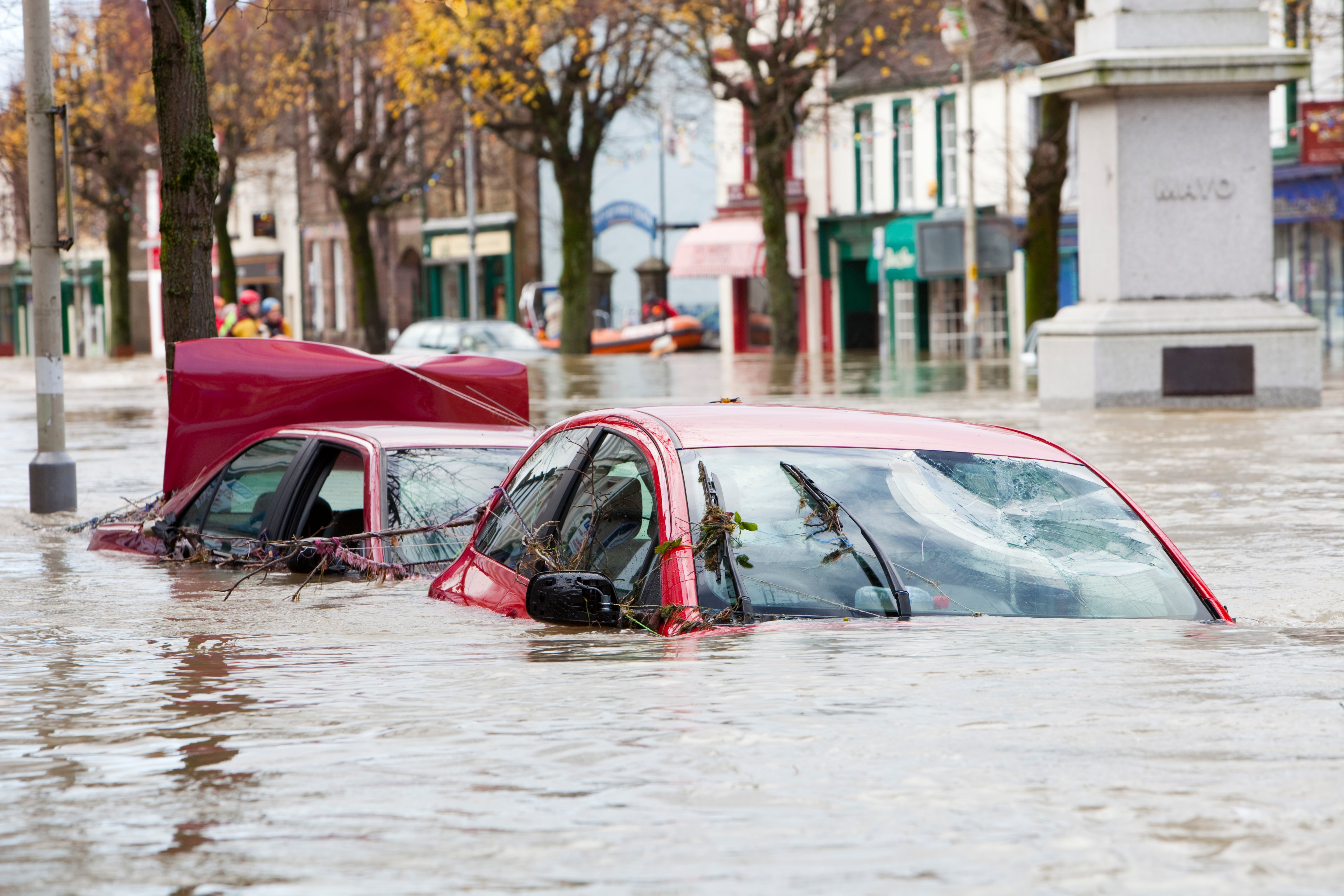 The climate crisis makes extreme weather events, such as heatwaves, hurricanes and floods, both more likely and more frequent. Here, flooded cars are pictured on Cockermouth Main Street
