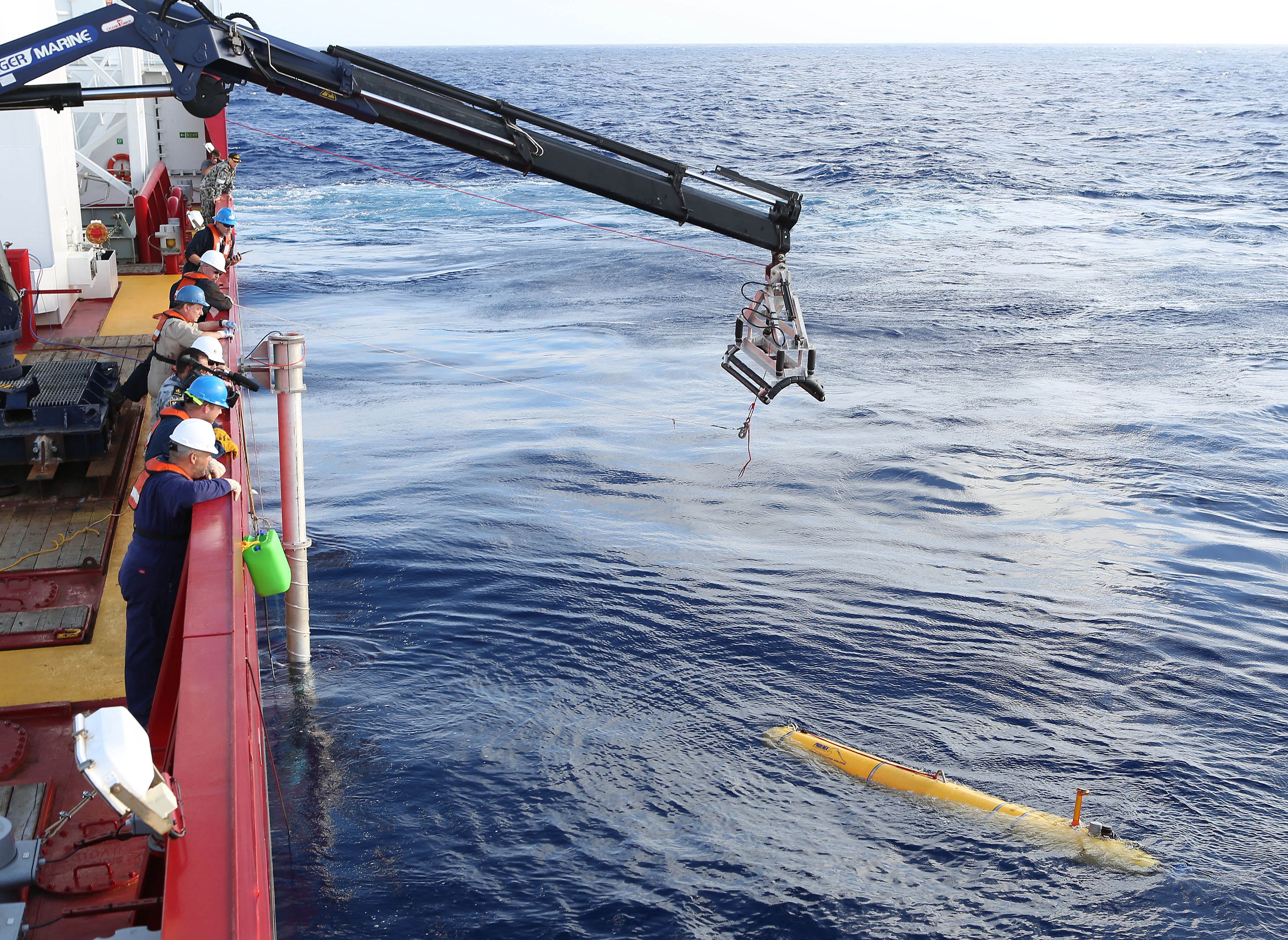 Debris from Malaysia Airlines flight MH 370 is lifted from the sea