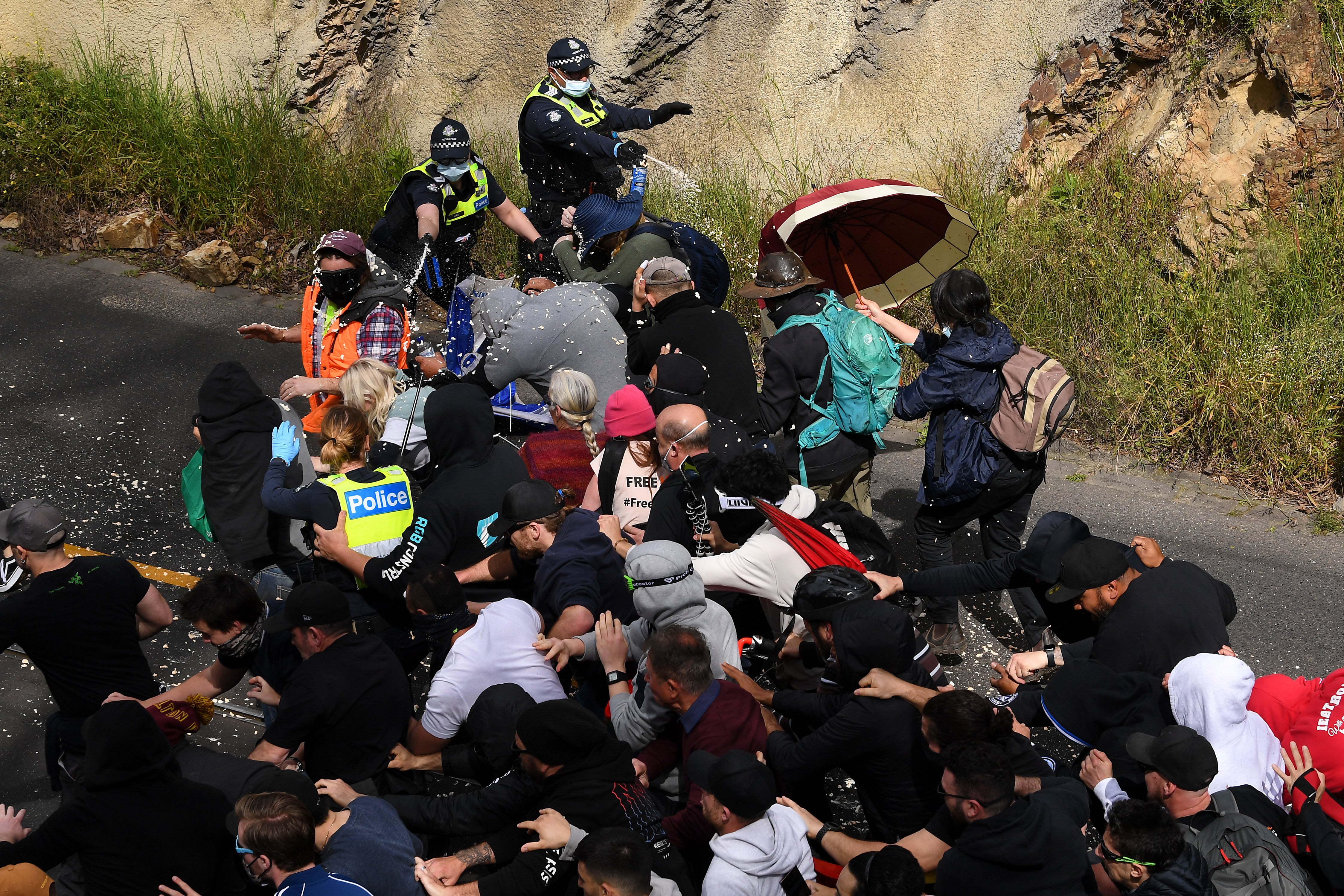 Police fire pepper spray at protesters during clash