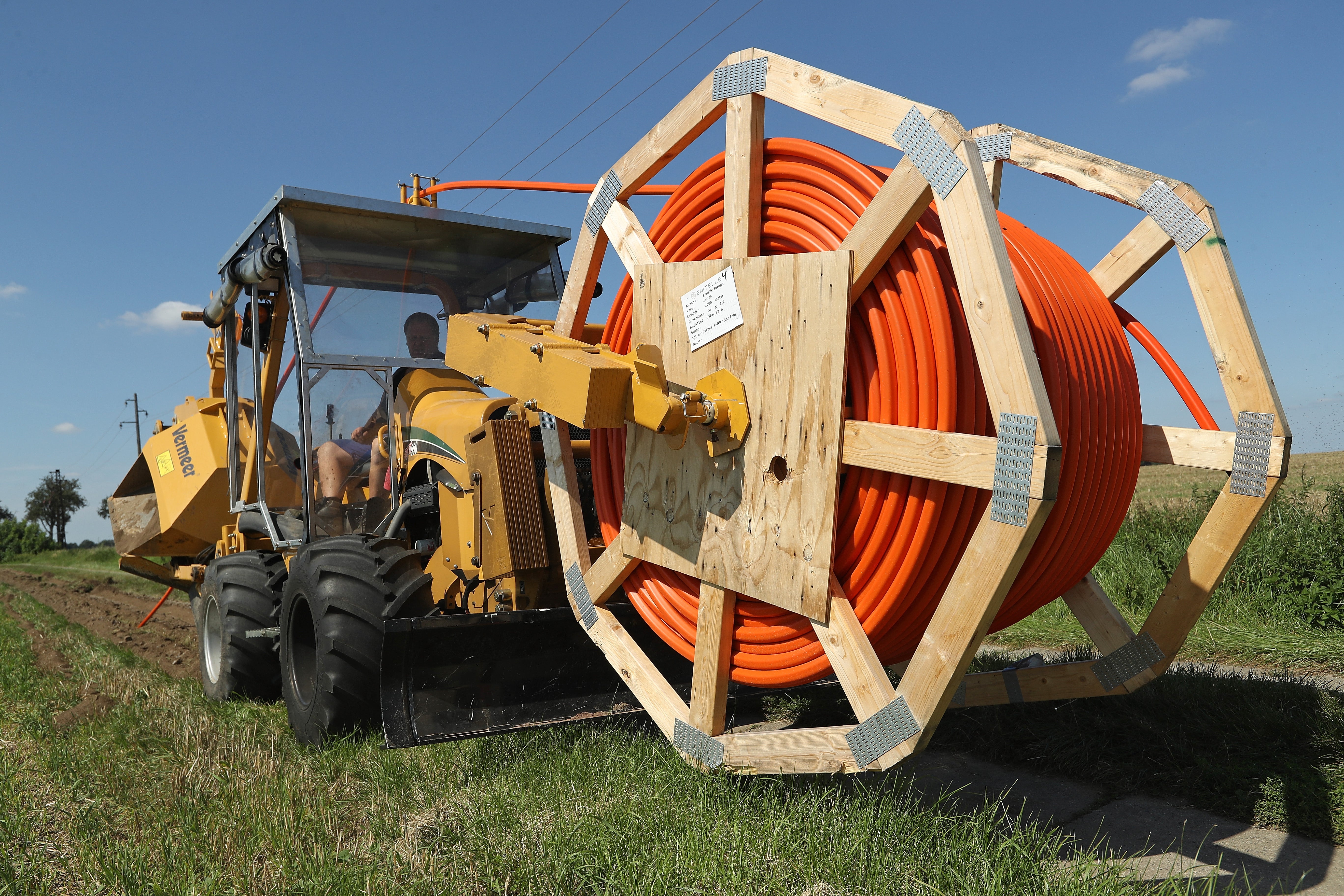 A worker laying tubing for fibre optic cable. France and Italy have much better broadband coverage than Germany