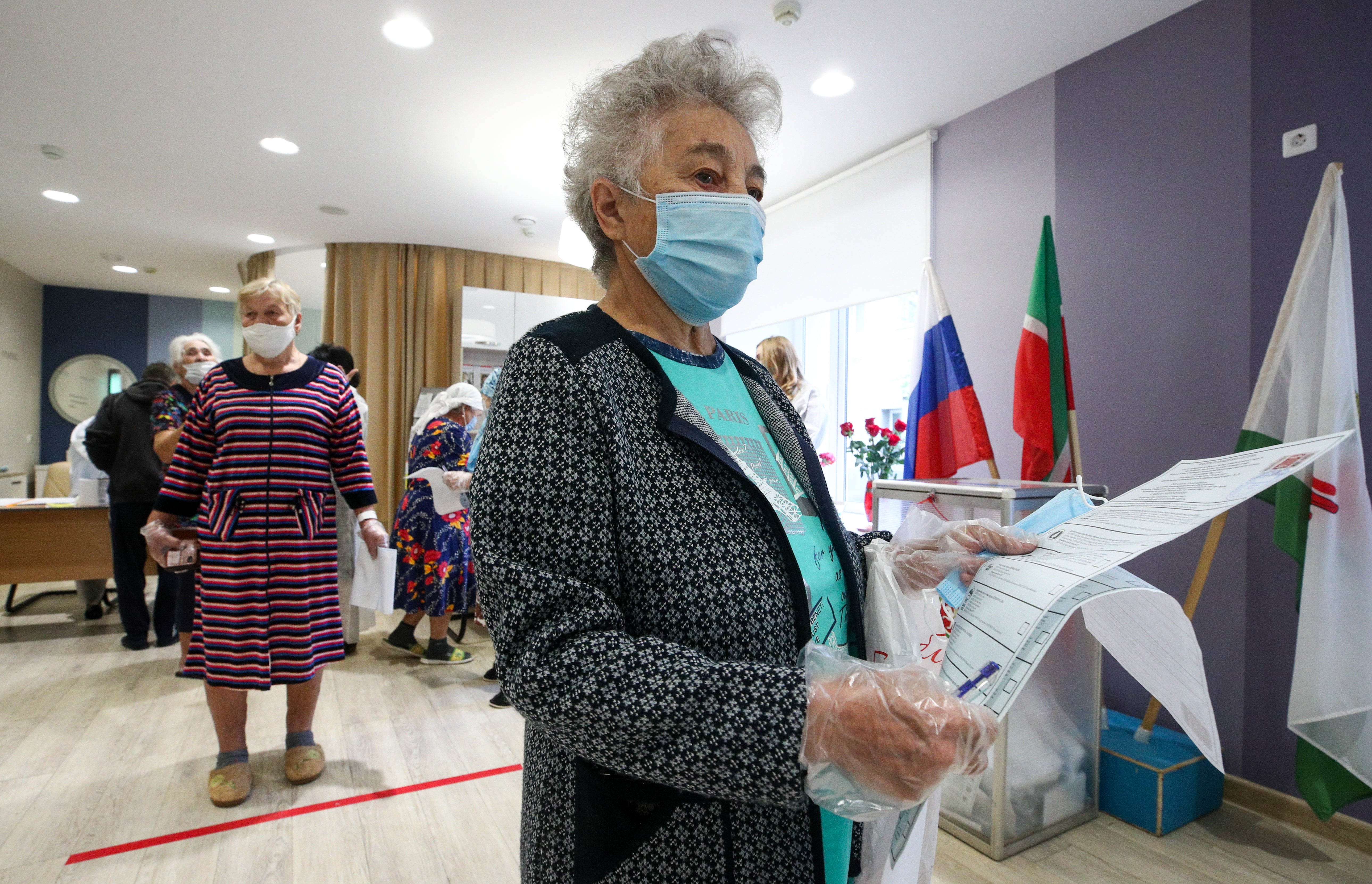 A voter holds ballots during the Russian parliamentary election at polling station 342 at the Republican Clinical Hospital in Kazan on Sunday