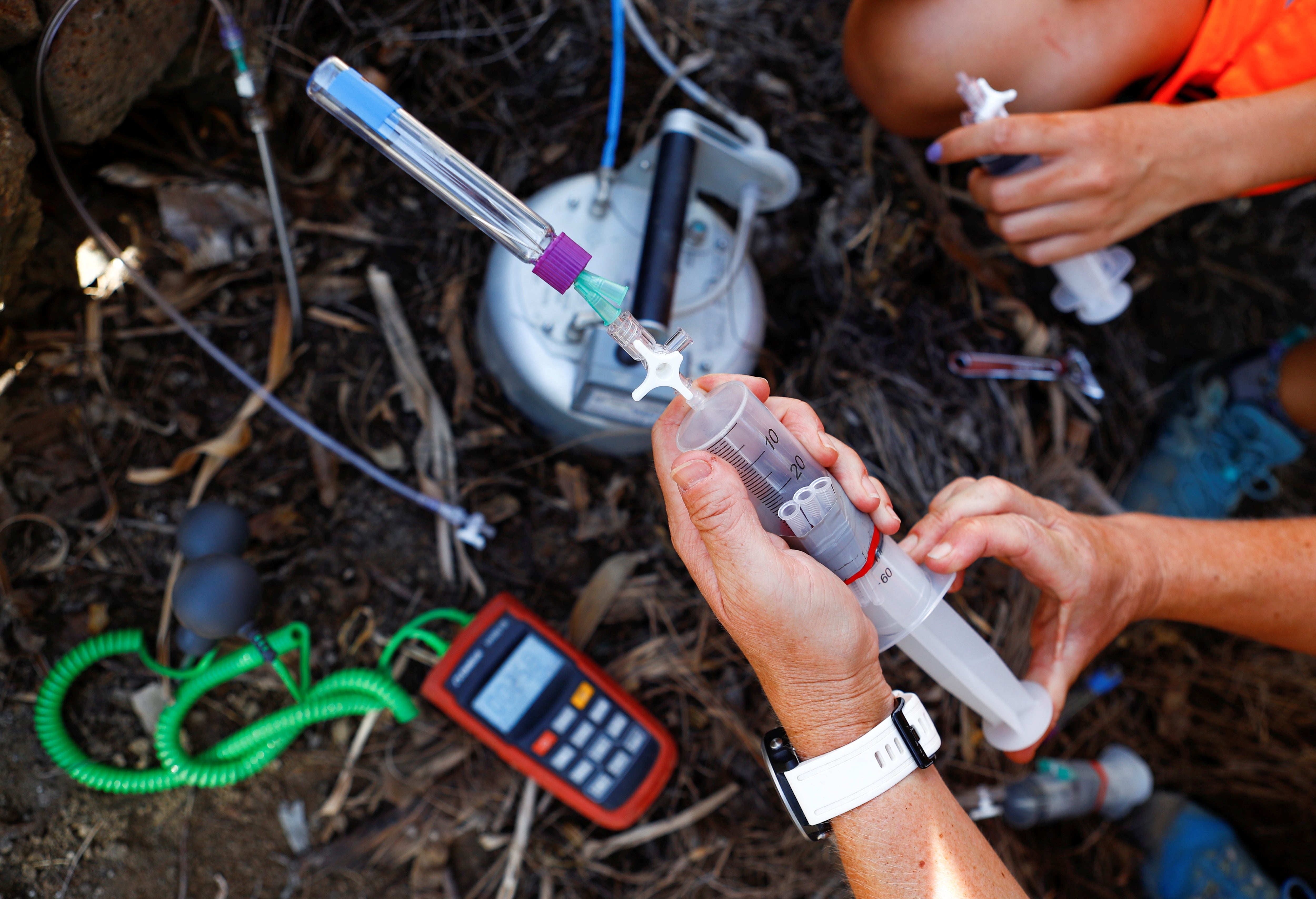 Two volcanologists from the Volcanological Institute of the Canary Islands collect gas samples in Tazacorte