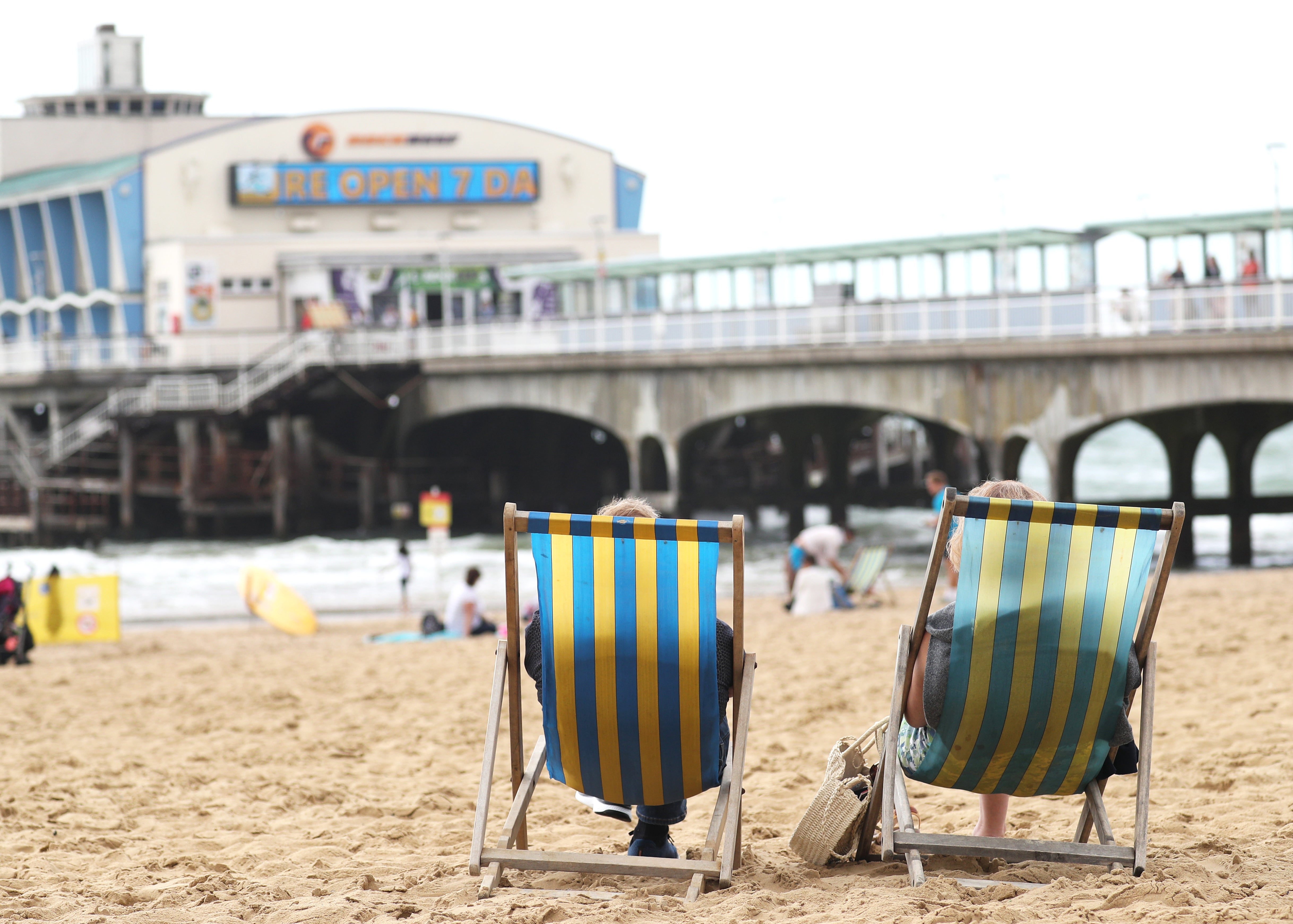 People relax on deckchairs (PA)