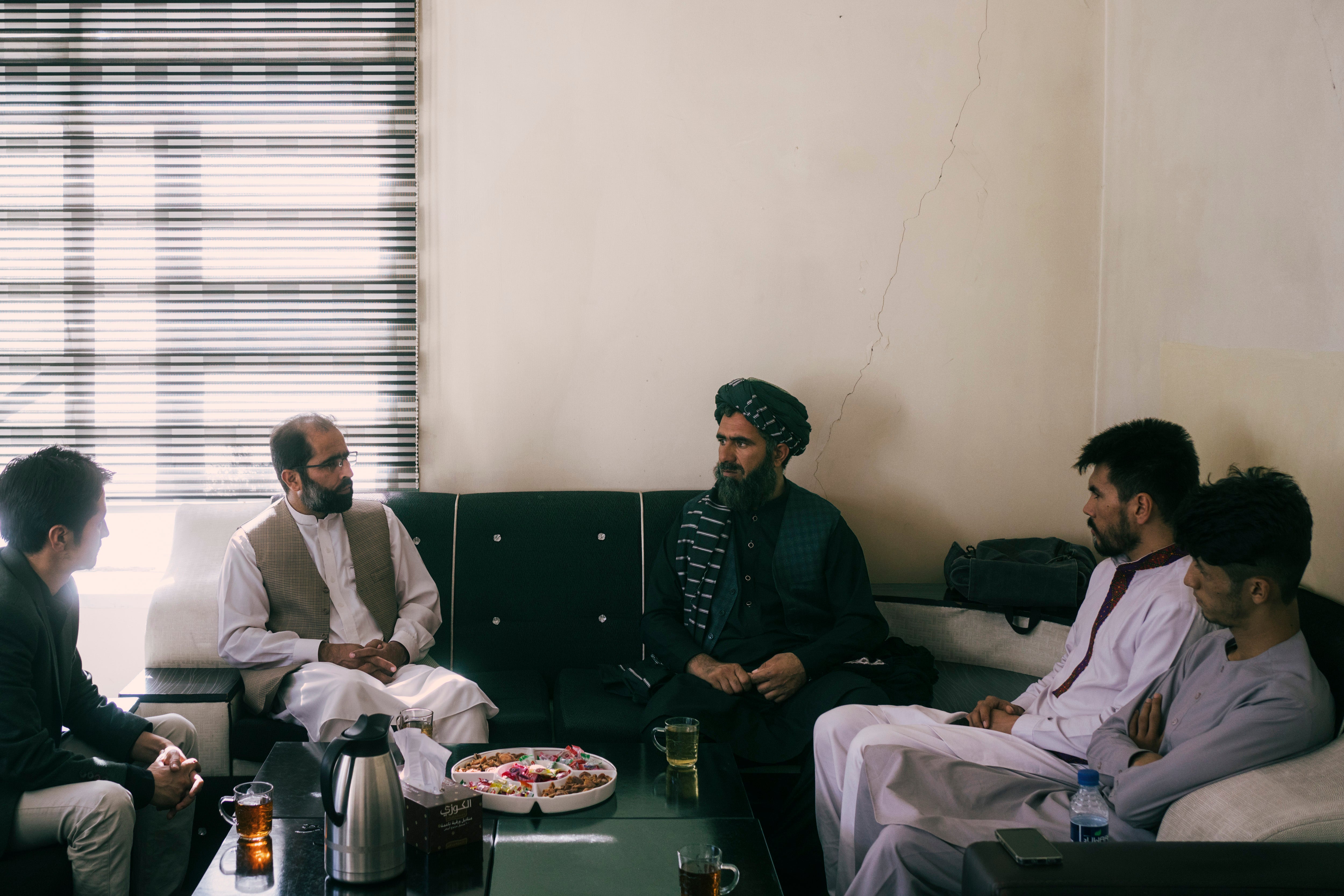 Two members of the Taliban’s media committee, Sarujullhaq Omari, centre, and Hujatullah Mujadidi, second from left, visit the offices of the Etilaatroz newspaper