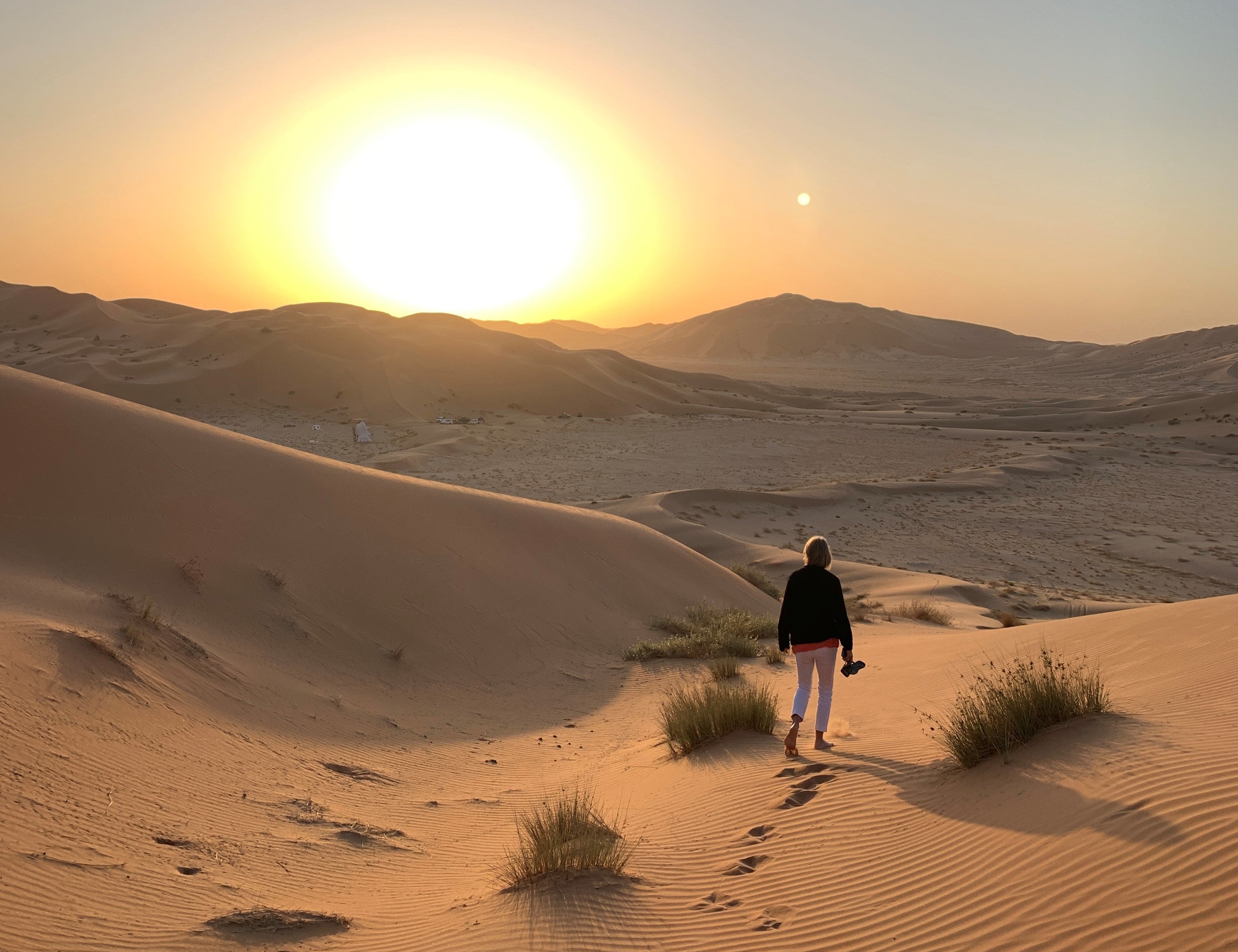 Shoes go first: A fellow member of the tour group stretches her toes in the desert sand