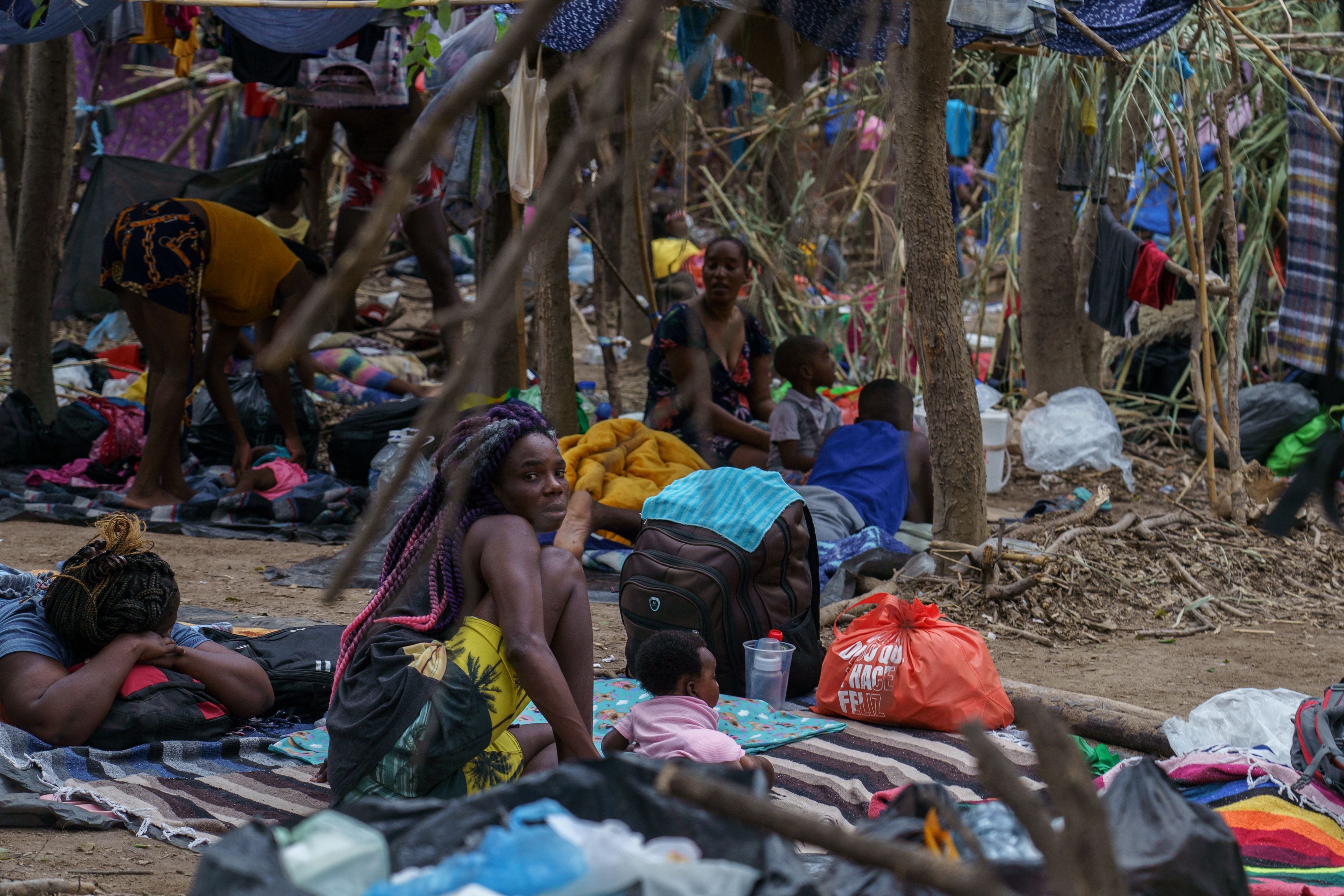 Haitian migrants are pictured in a makeshift encampment where more than 12,000 people hoping to enter the United States await under the international bridge in Del Rio, Texas on 21 September 2021