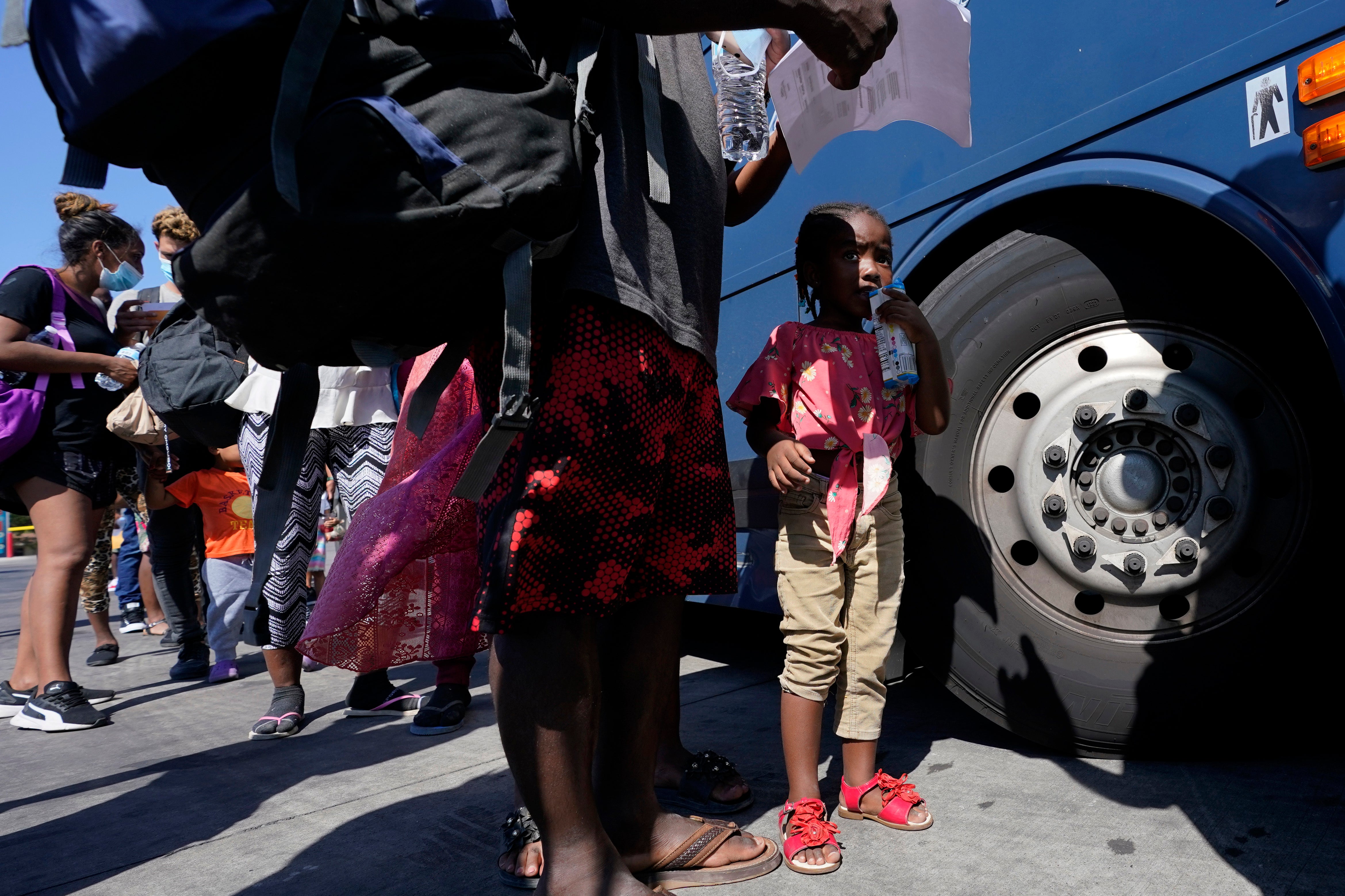 Migrants, many from Haiti, board a bus after they were processed and released after spending time at a makeshift camp near the International Bridge, Monday, 20 September 2021, in Del Rio, Texas