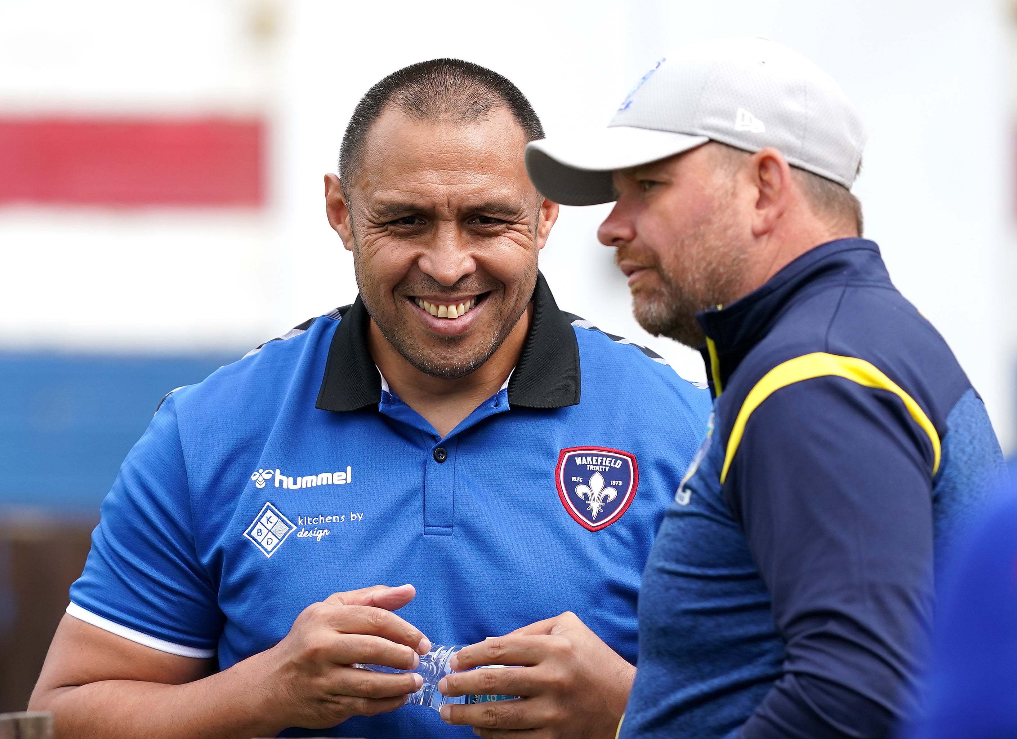 Willie Poching, left, in discussions with Warrington assistant coach Lee Briers before a Super League match at the Mobile Rocket Stadium in August (Martin Rickett/PA)