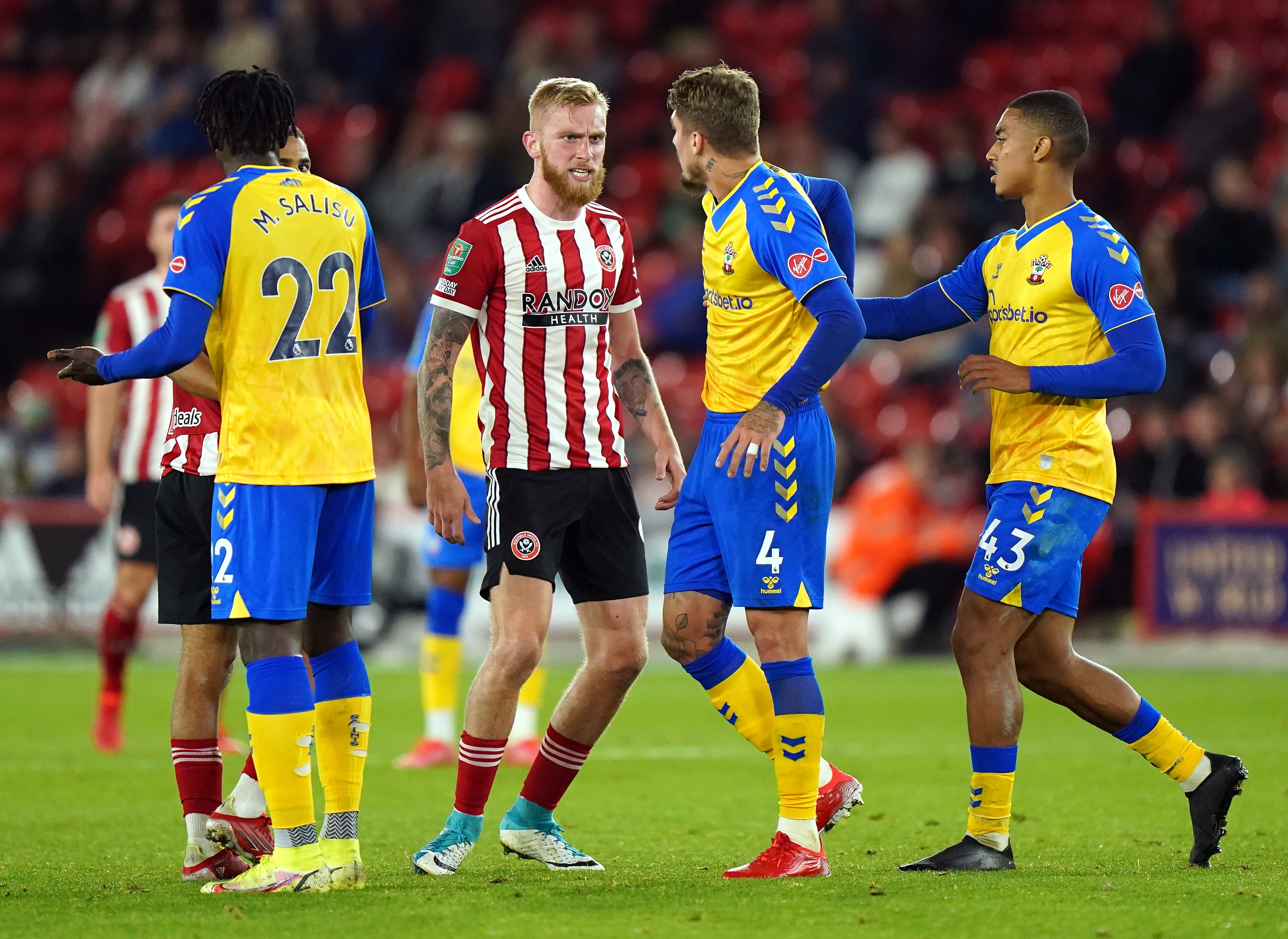 Lyanco exchanges words with Sheffield United’s Oli McBurnie (Tim Goode/PA).