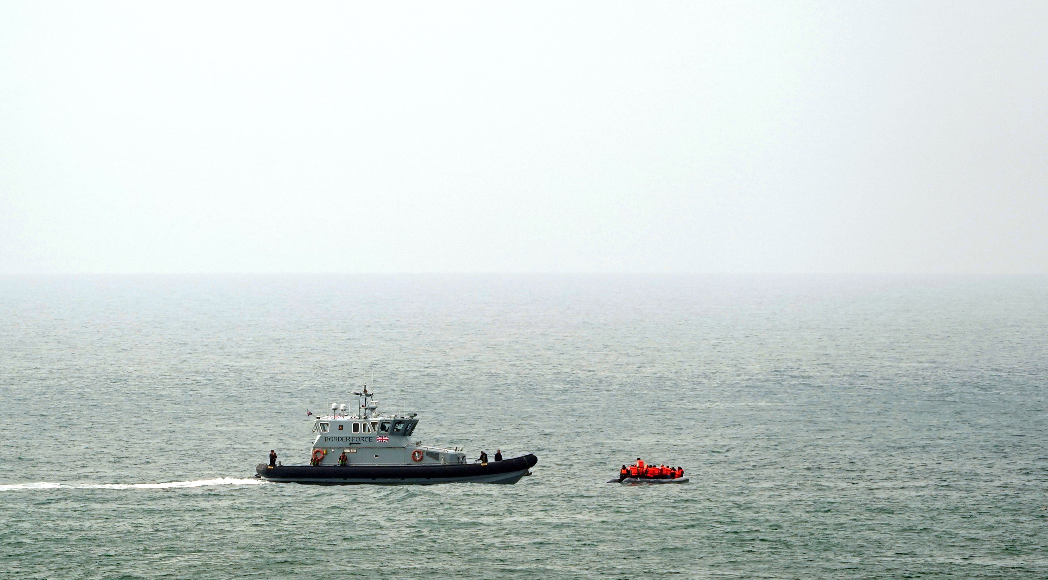 A Border Force vessel intercepts a group of people thought to be migrants in a small boat off the coast of Dover in Kent