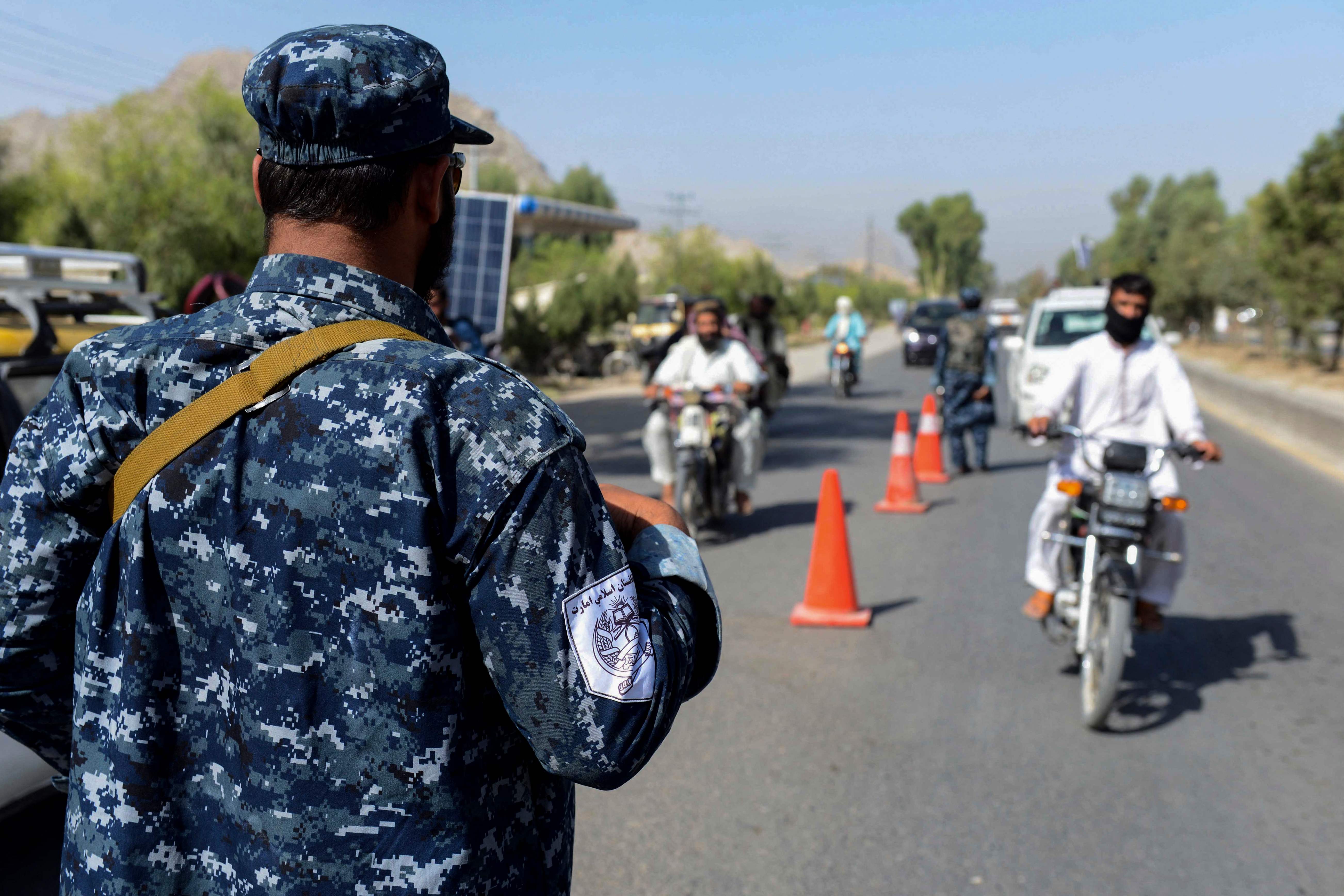 A Taliban fighter is shown at a checkpoint in Kandahar on 21 September, 2021.