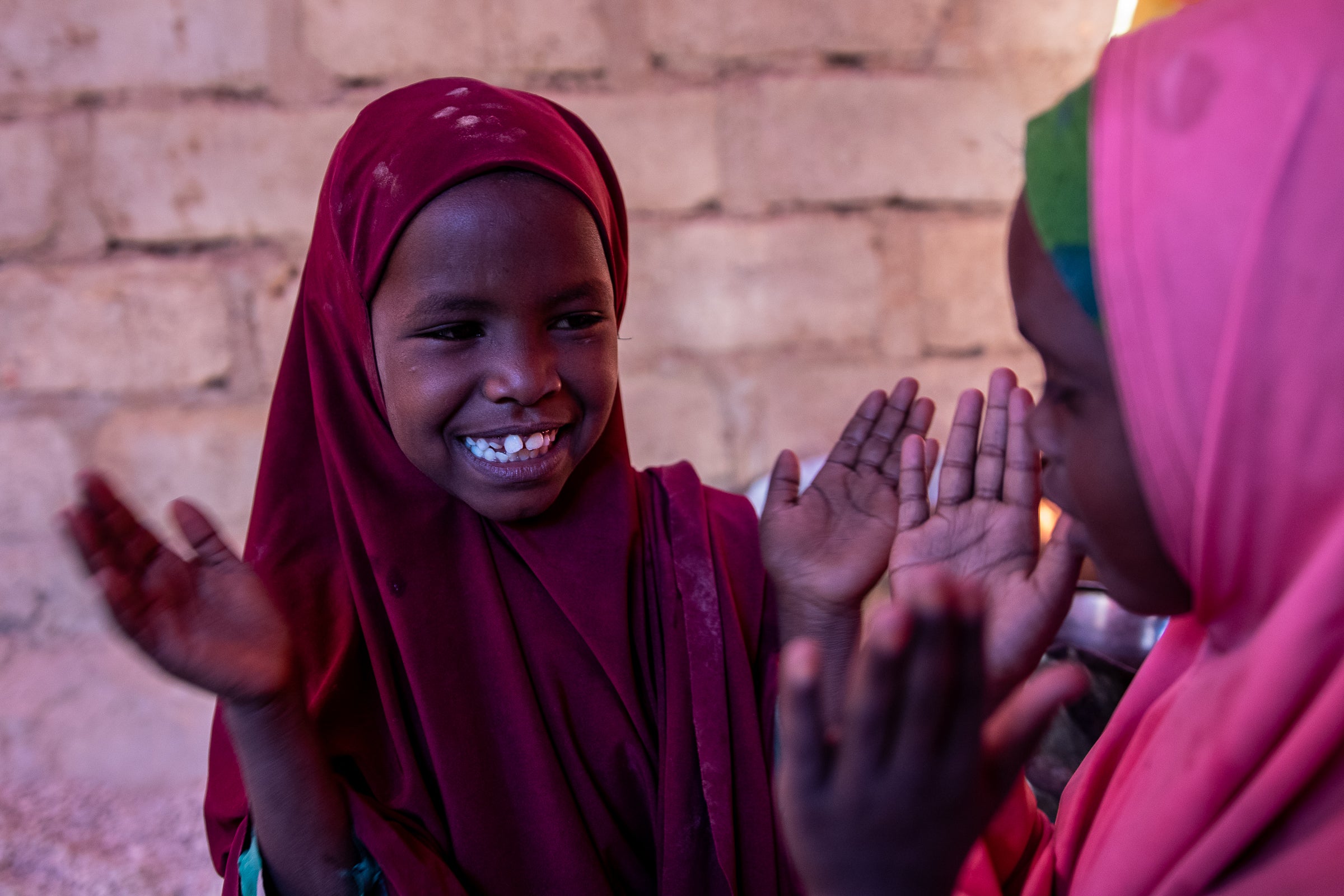 Sahra (right) and her sister Adia (left) have been helped by vital, long-term projects run by Save the Children including a water trucking programme and schooling support