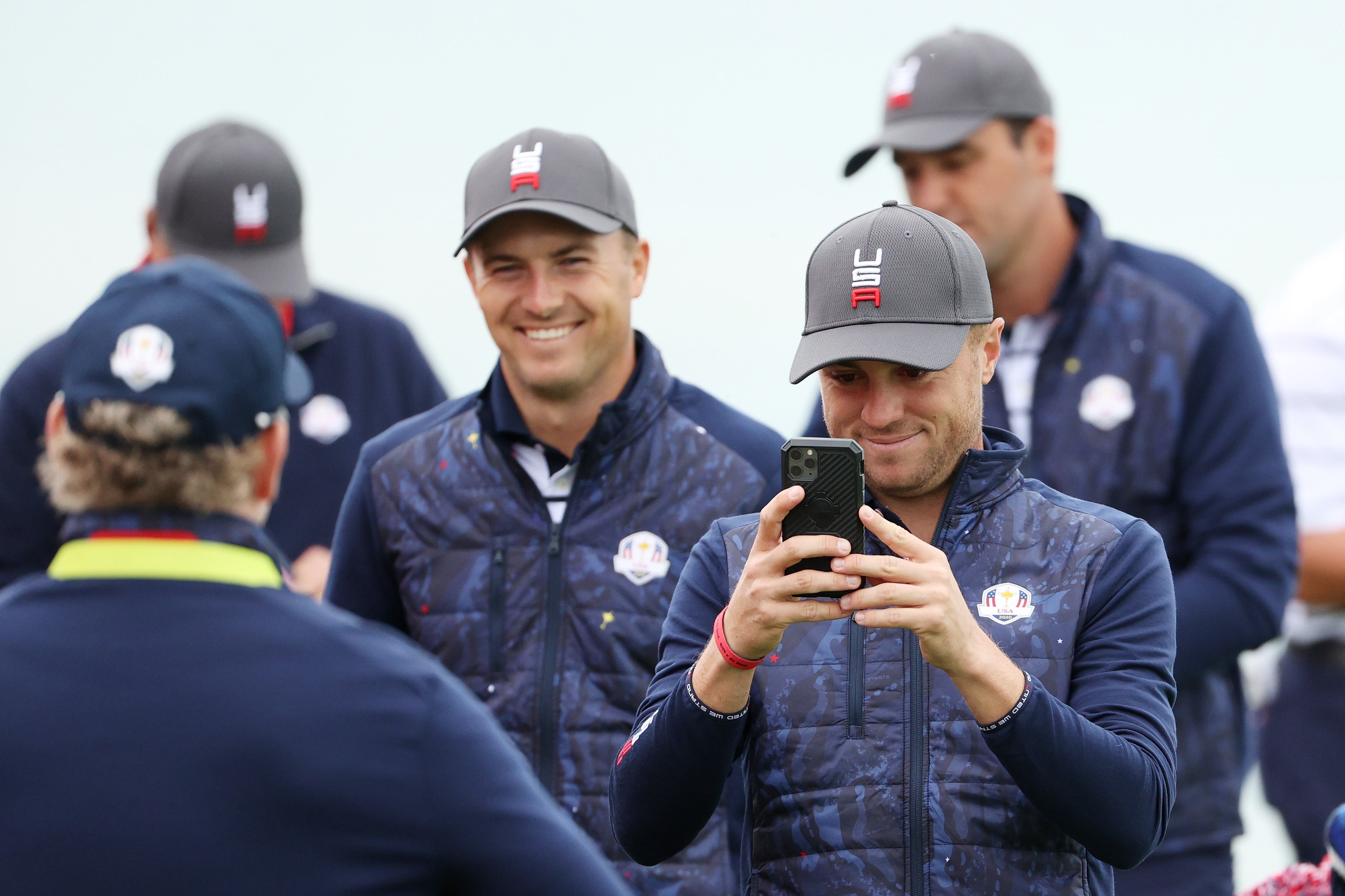 Jordan Spieth of team United States (L) and Justin Thomas of team United States take photos on the third green