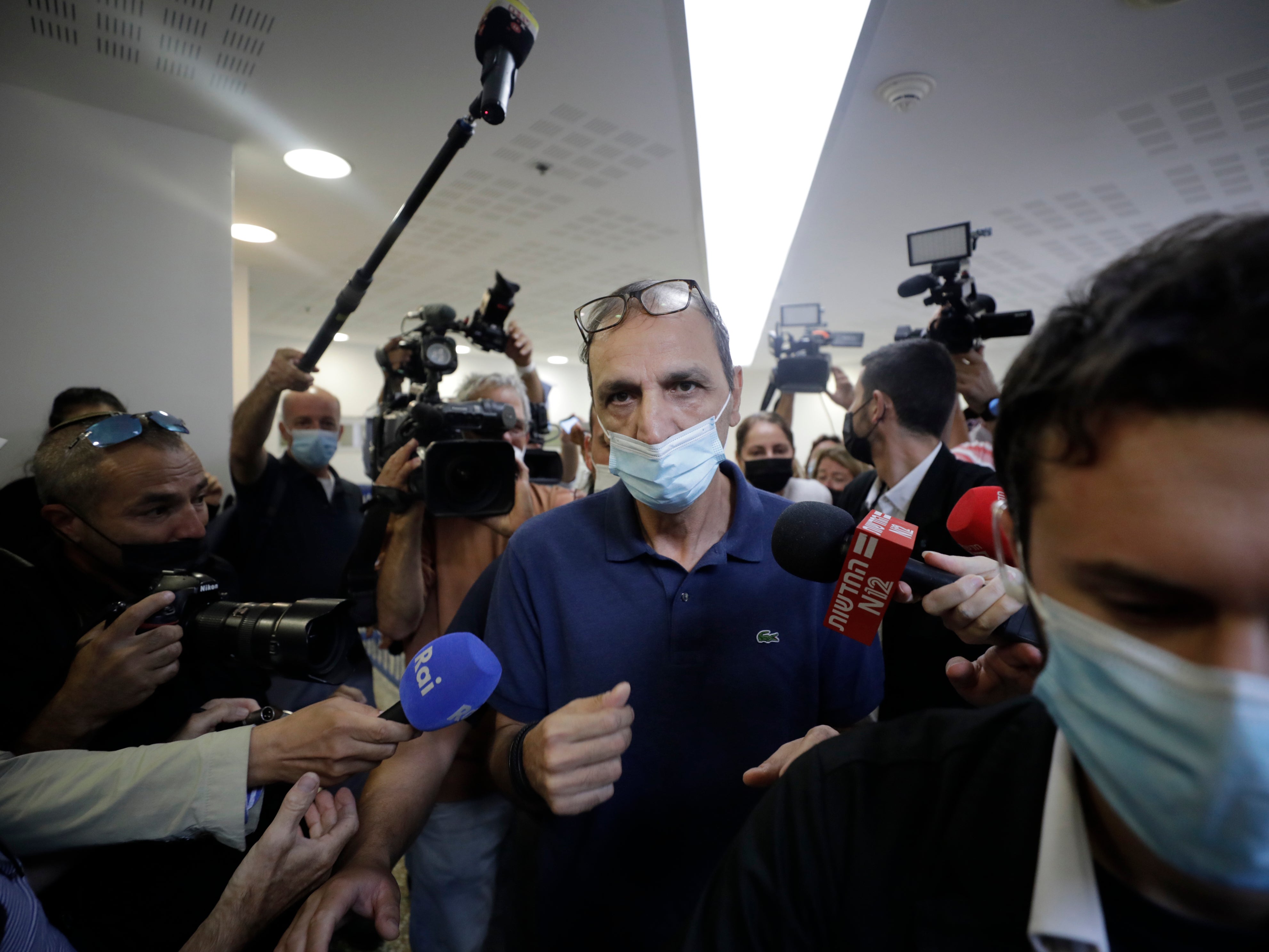 Shmulik Peleg, who spirited away his grandson Eitan Biran from Italy, is surrounded by the media as he leaves court in Tel Aviv