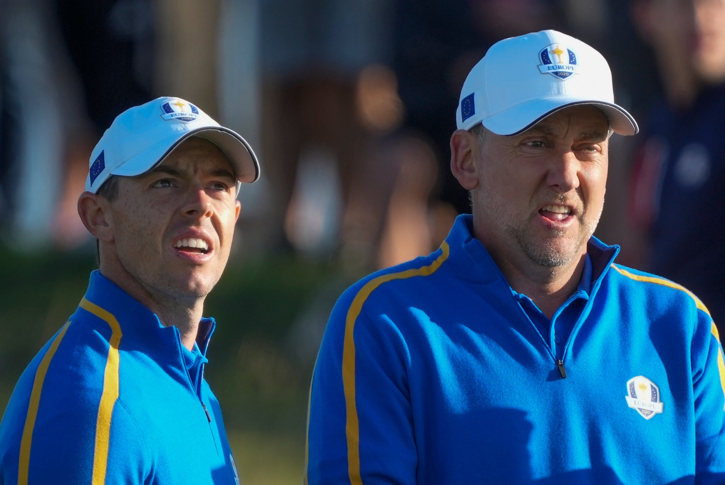 Rory McIlroy and Ian Poulter look over a shot on the second hole during their foursomes match at the Ryder Cup (Charlie Neibergall/AP)