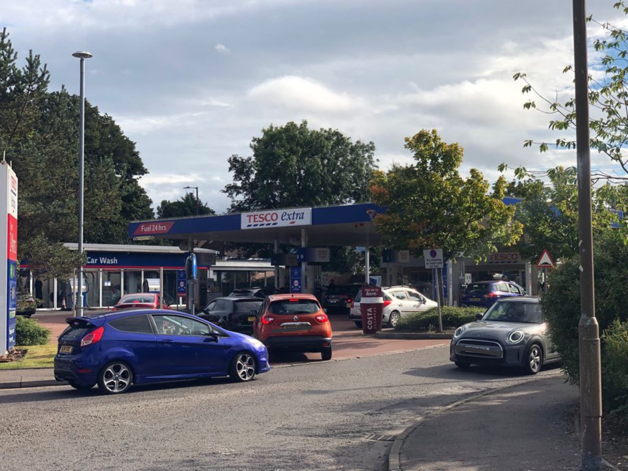 Cars queue outside a petrol station amid reports of panic buying