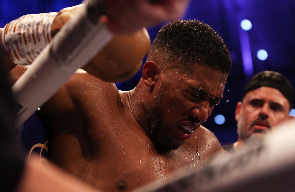 Joshua cuts a dejected figure in his corner on Saturday night at the Tottenham Hotspur Stadium