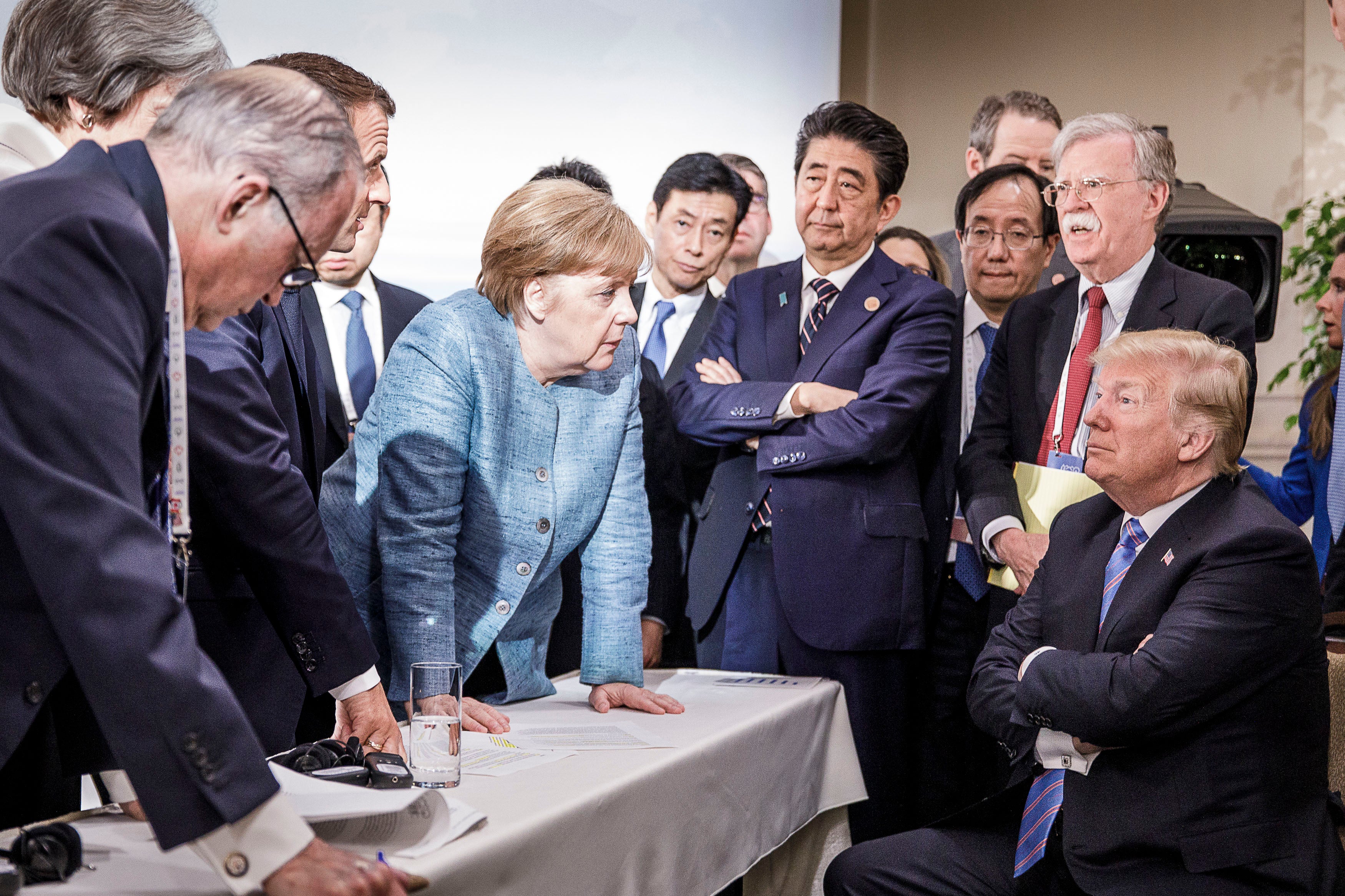 Merkel deliberates with Donald Trump at the 2018 G7 summit in Charlevoix, Canada