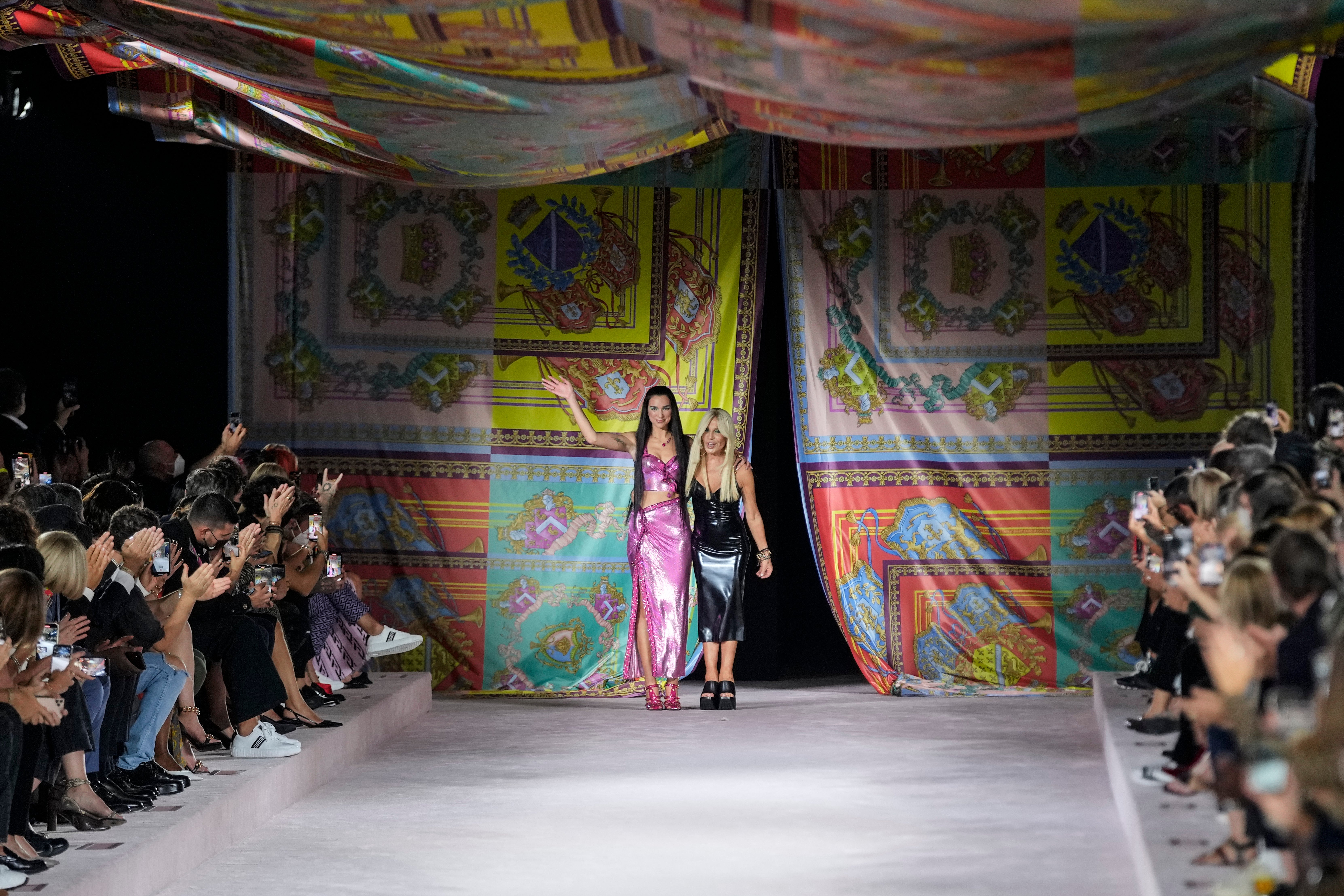 Dua Lipa, left, and Donatella Versace at the Versace show at Milan Fashion Week (Luca Bruno/AP)