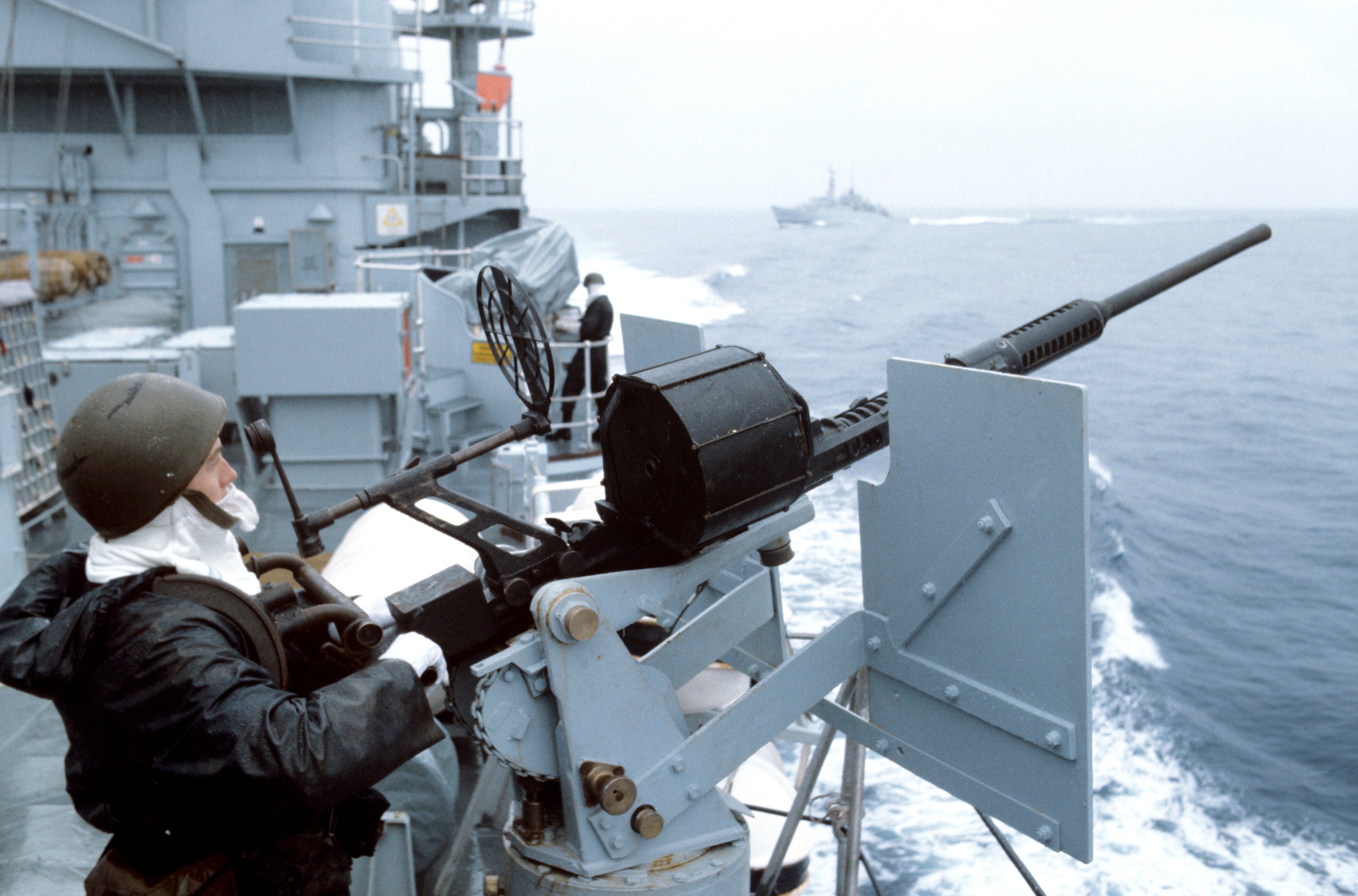 A royal navy sailor manning an anti-aircraft gun aboard HMS Hermes as the British taskforce sails south to the Falkland Islands