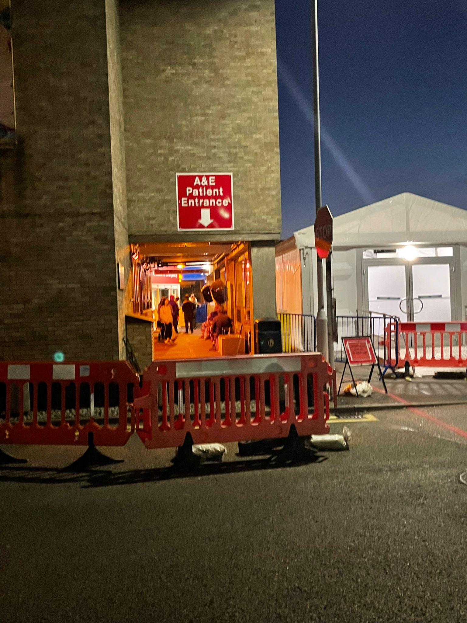 Patients wait under heat lamps outside Addenbrooke’s Hospital A&E department