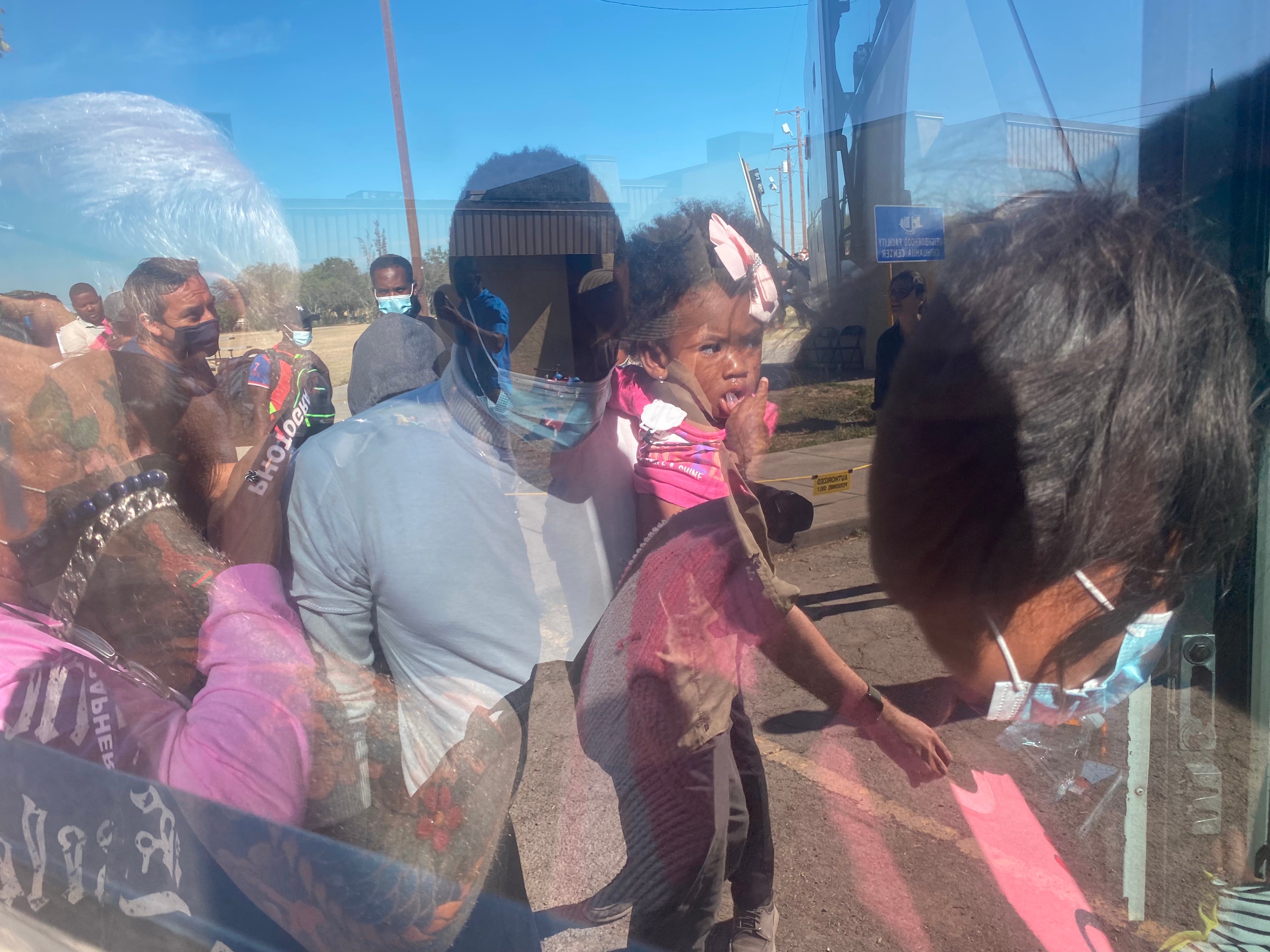 Migrants get on a bus in Del Rio after being paroled by immigration authorities