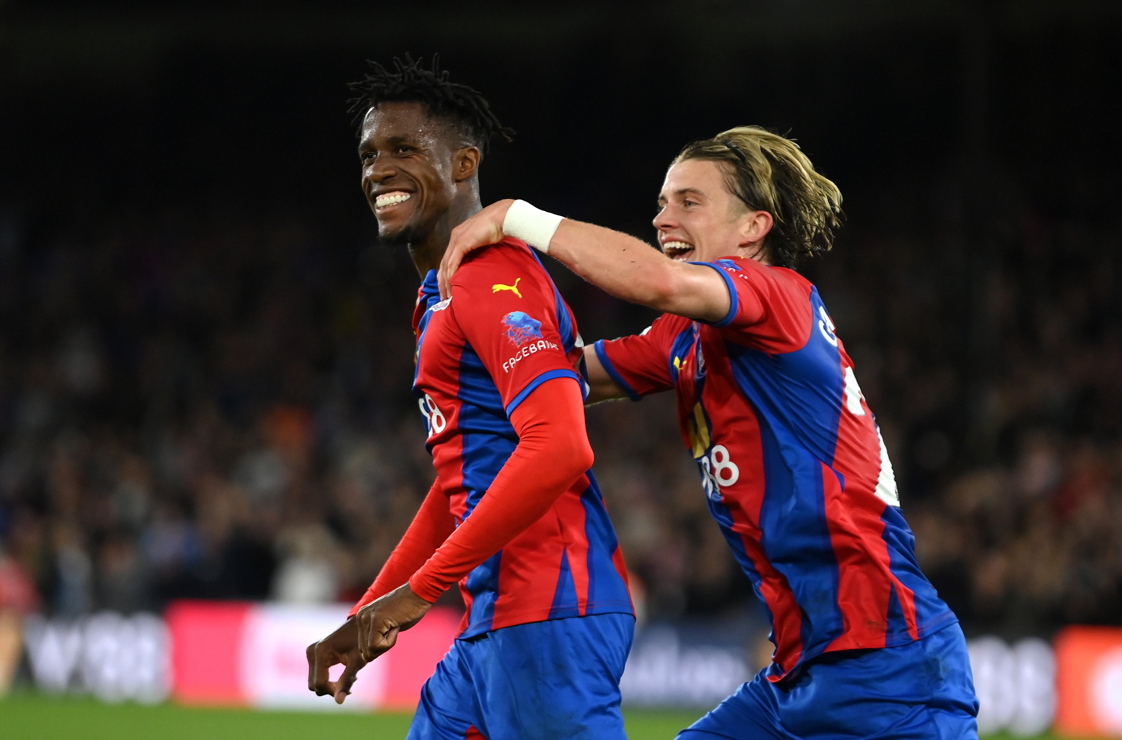 Wilfried Zaha (left) celebrates with Conor Gallagher after giving Crystal Palace the lead