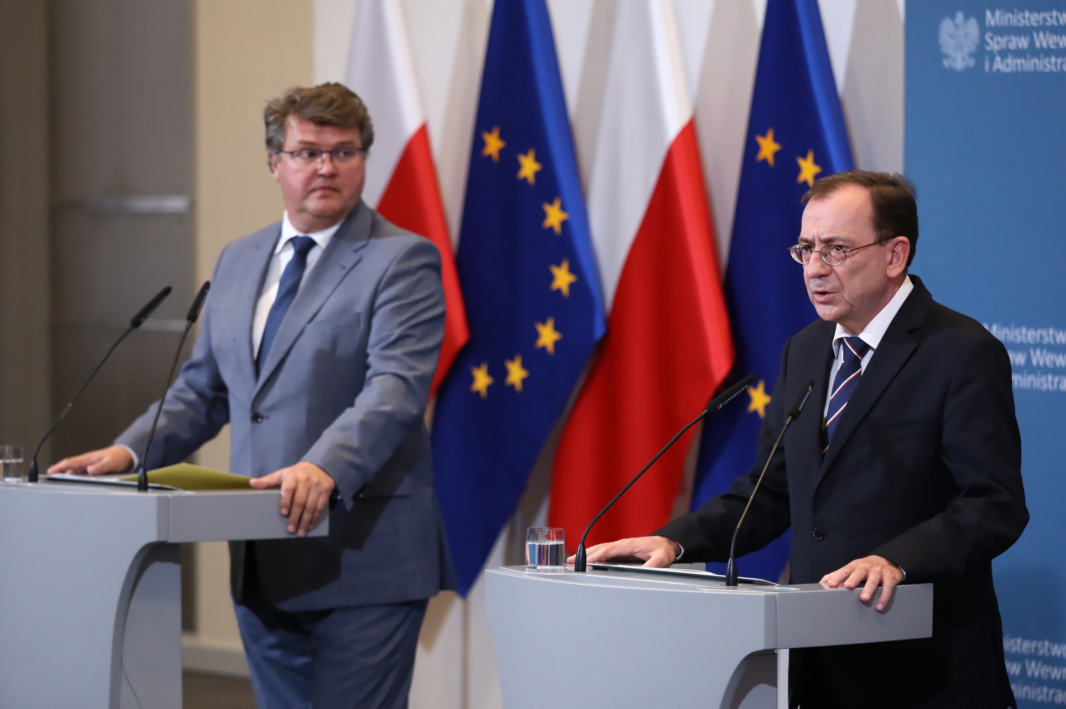 Polish Interior Minister Mariusz Kaminski (R) and Deputy Minister Maciej Wasik (L) attend a press conference on the state of emergency near Poland-Belarus border