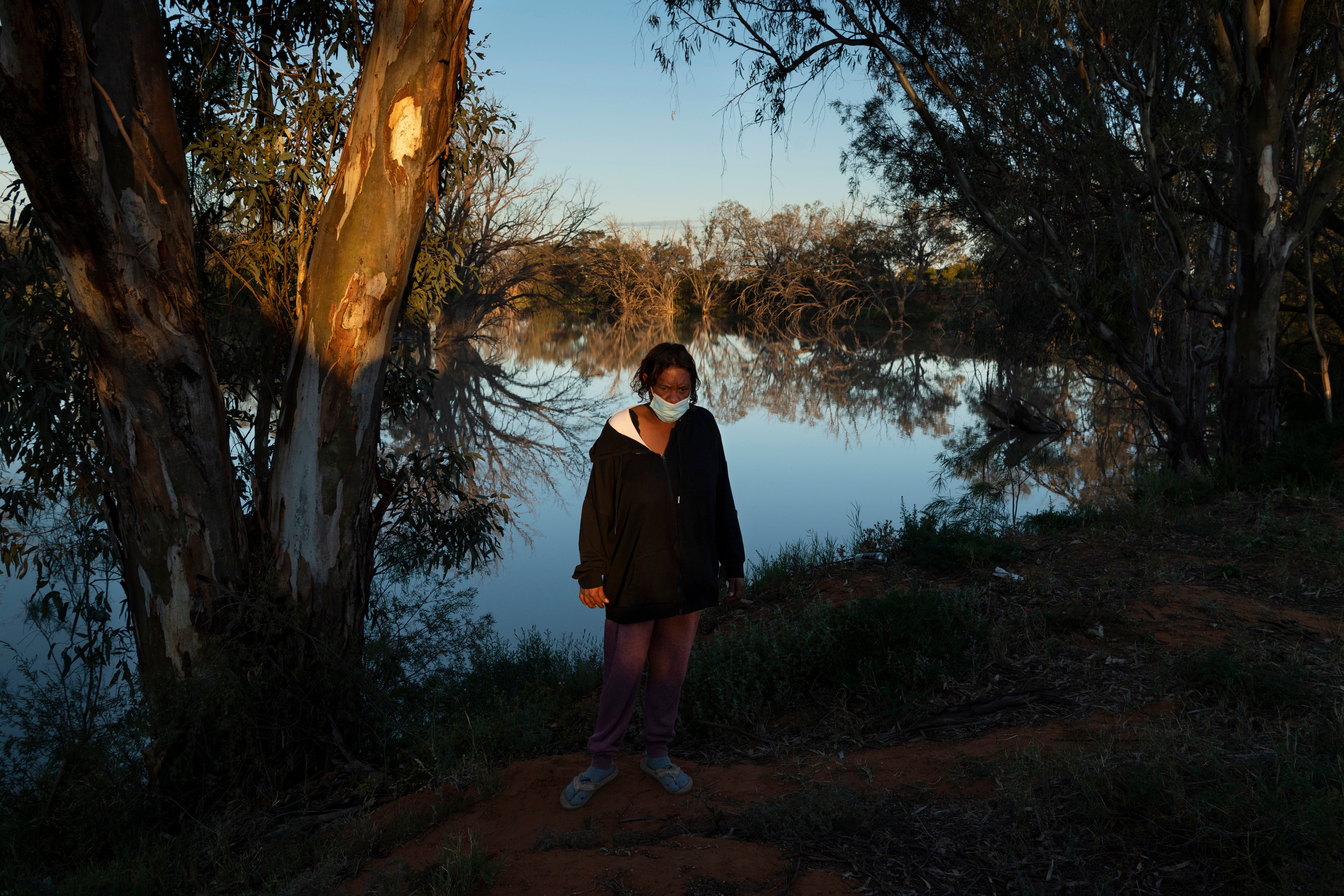 Catherine Bugmy was forced to wash her clothes in the river next to her isolation camp because she tested positive and was not allowed to use the communal washing facilities