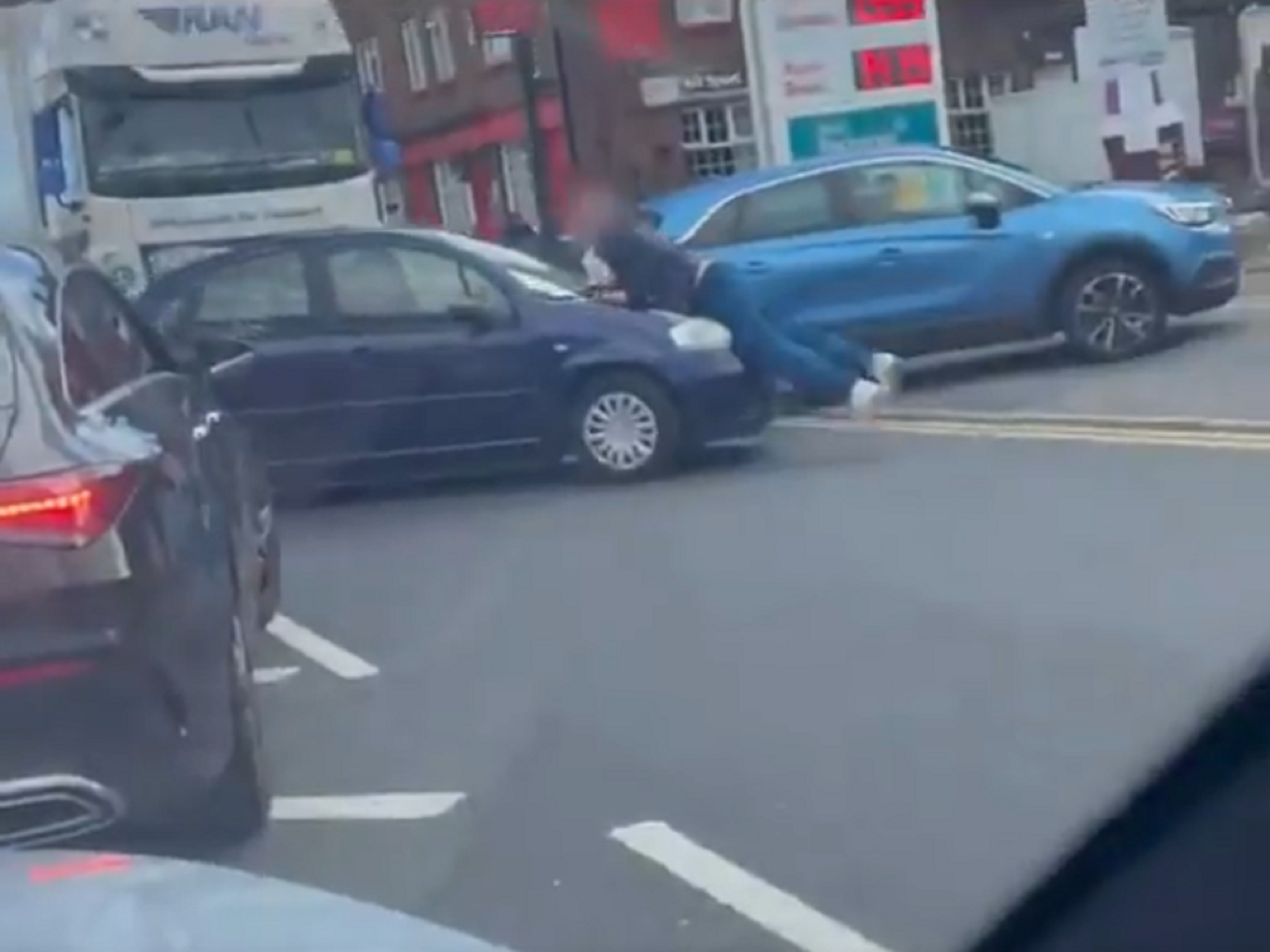 The man clung on to the bonnet as the driver attempted to flee