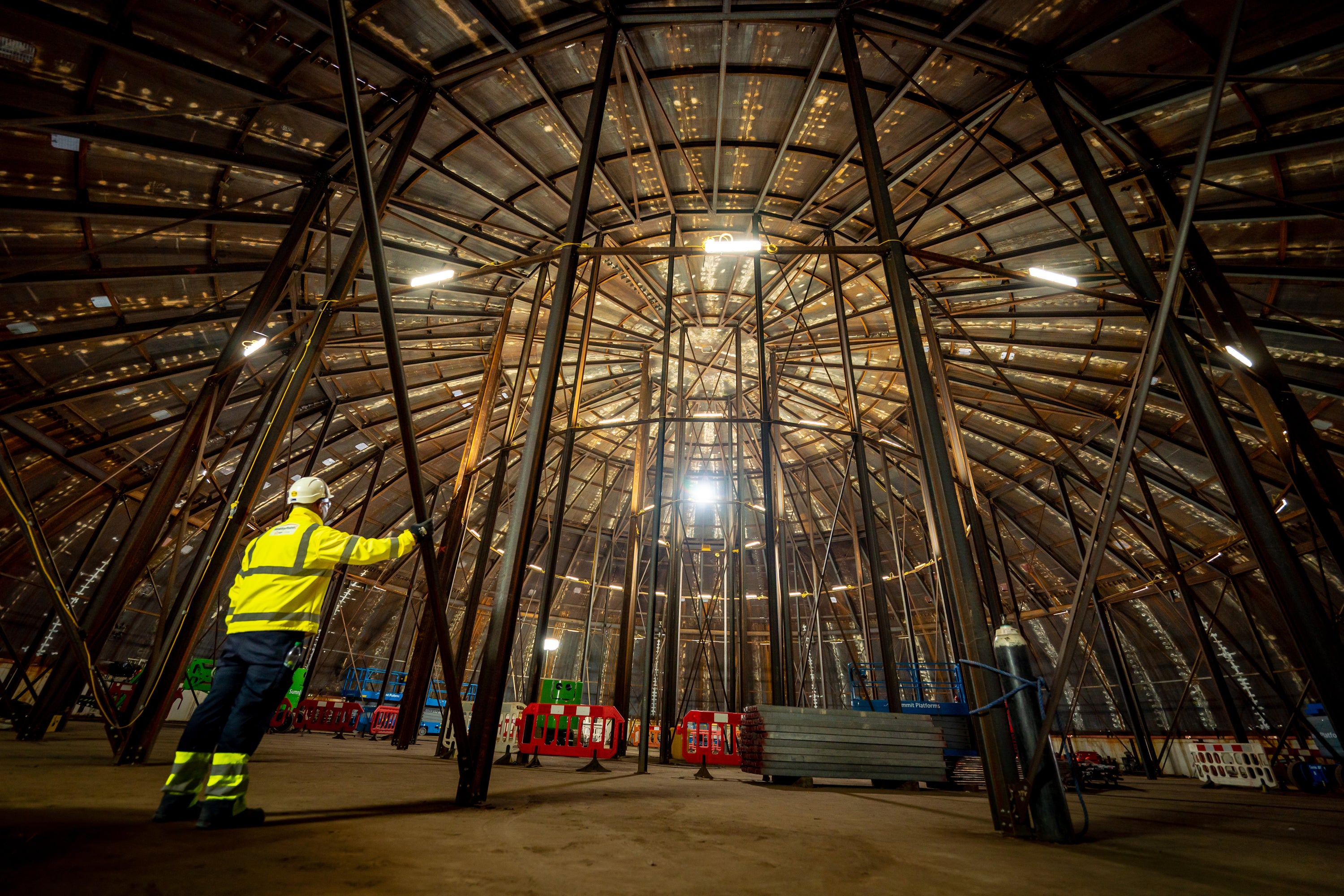 A construction worker stands inside a welded steel dome at Hinkley Point C nuclear power plant (Ben Birchall/PA)