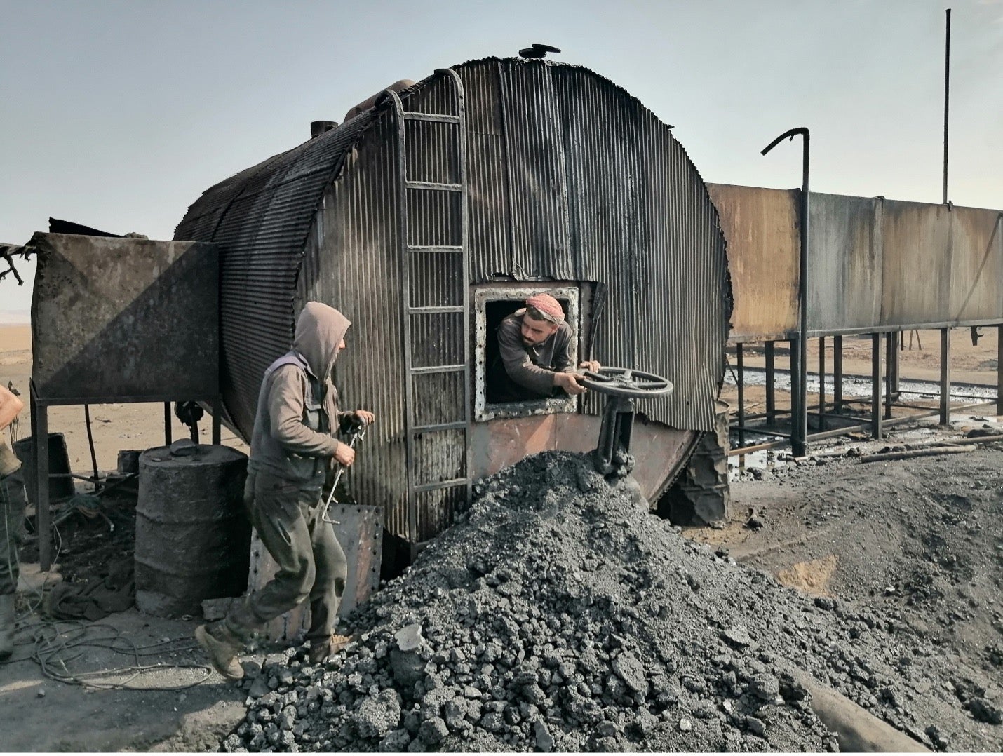 ‘We know that working here is deadly, but whoever does not die of disease will starve to death’: workers clean a makeshift oil refinery in Qahtaniya, east of Qamishli city