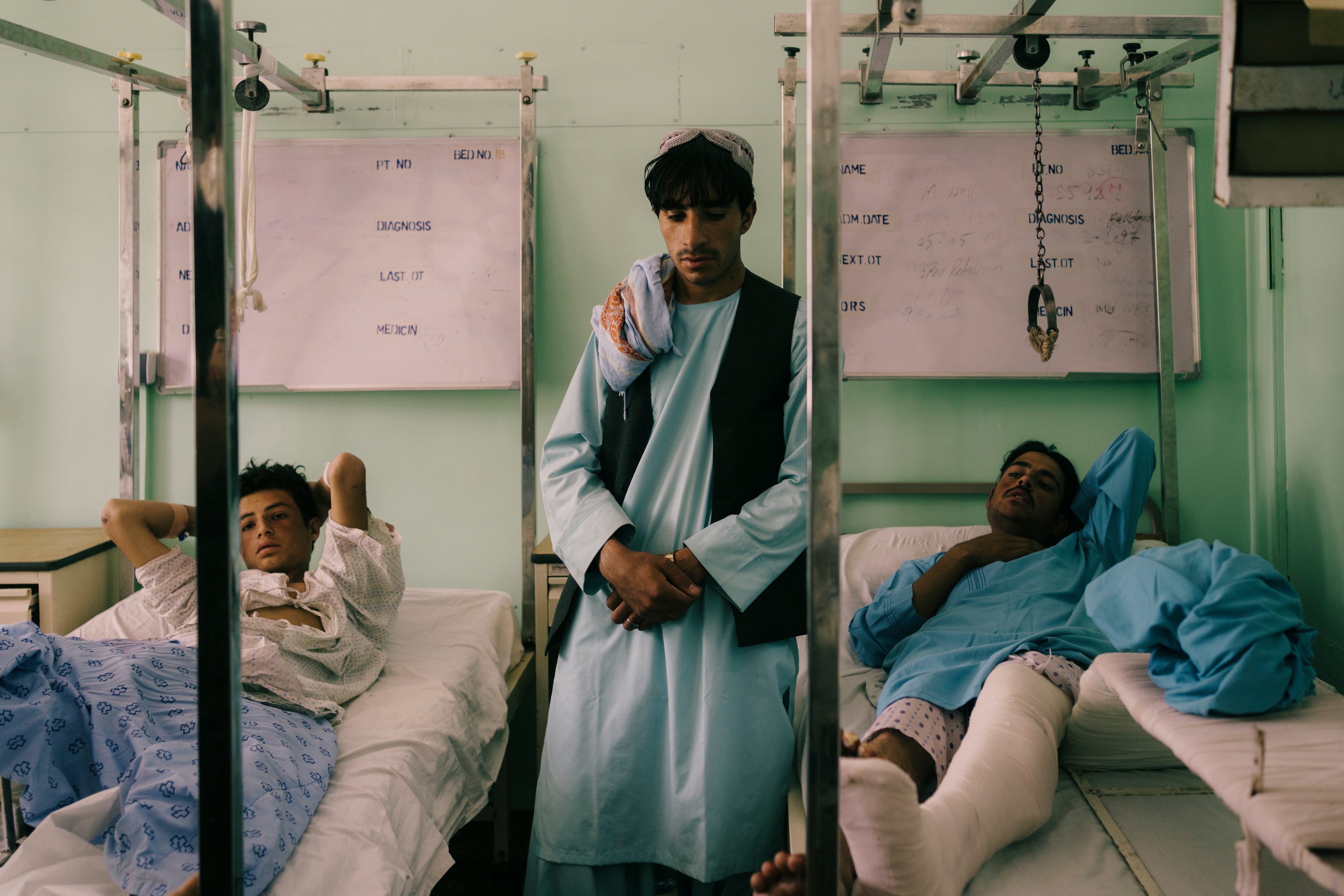 Policemen injured on the front lines recover in Kandahar’s main hospital on 31 July, just two weeks before the Taliban took control of the country