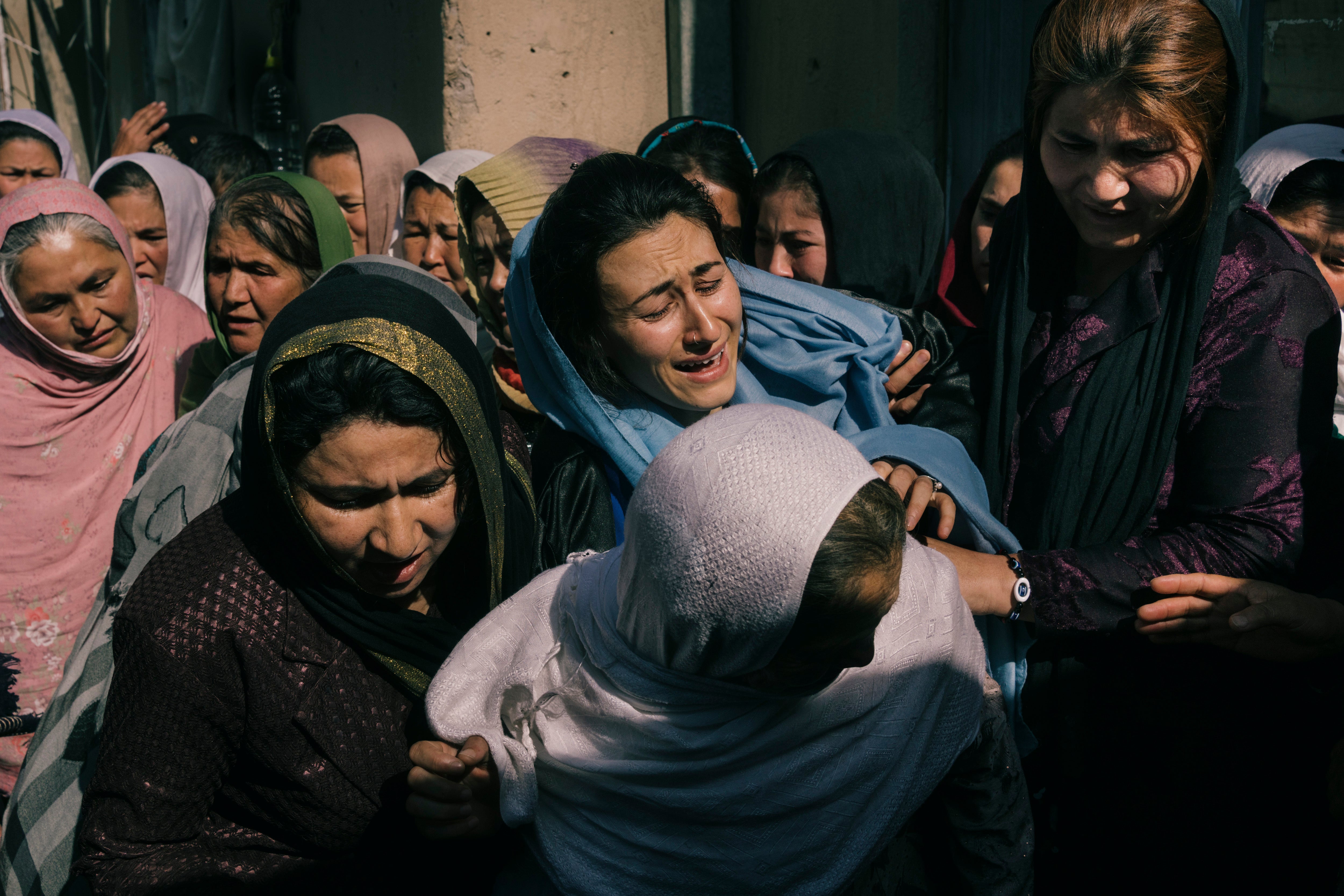 Family members attend a funeral in May for Niazi, an Afghan national army soldier who was killed after his outpost was surrounded by the Taliban