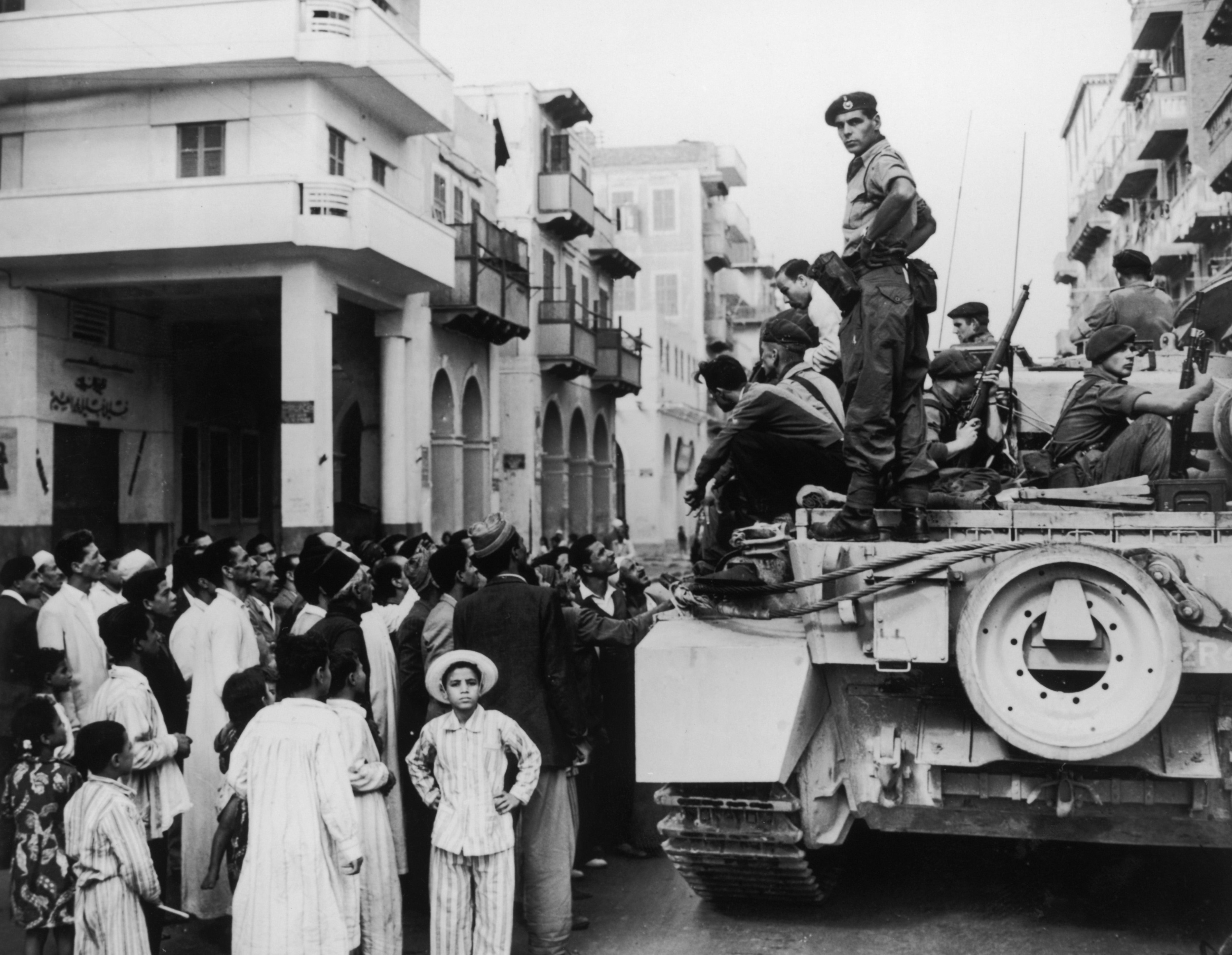 Egyptians crowd a British tank in Port Said