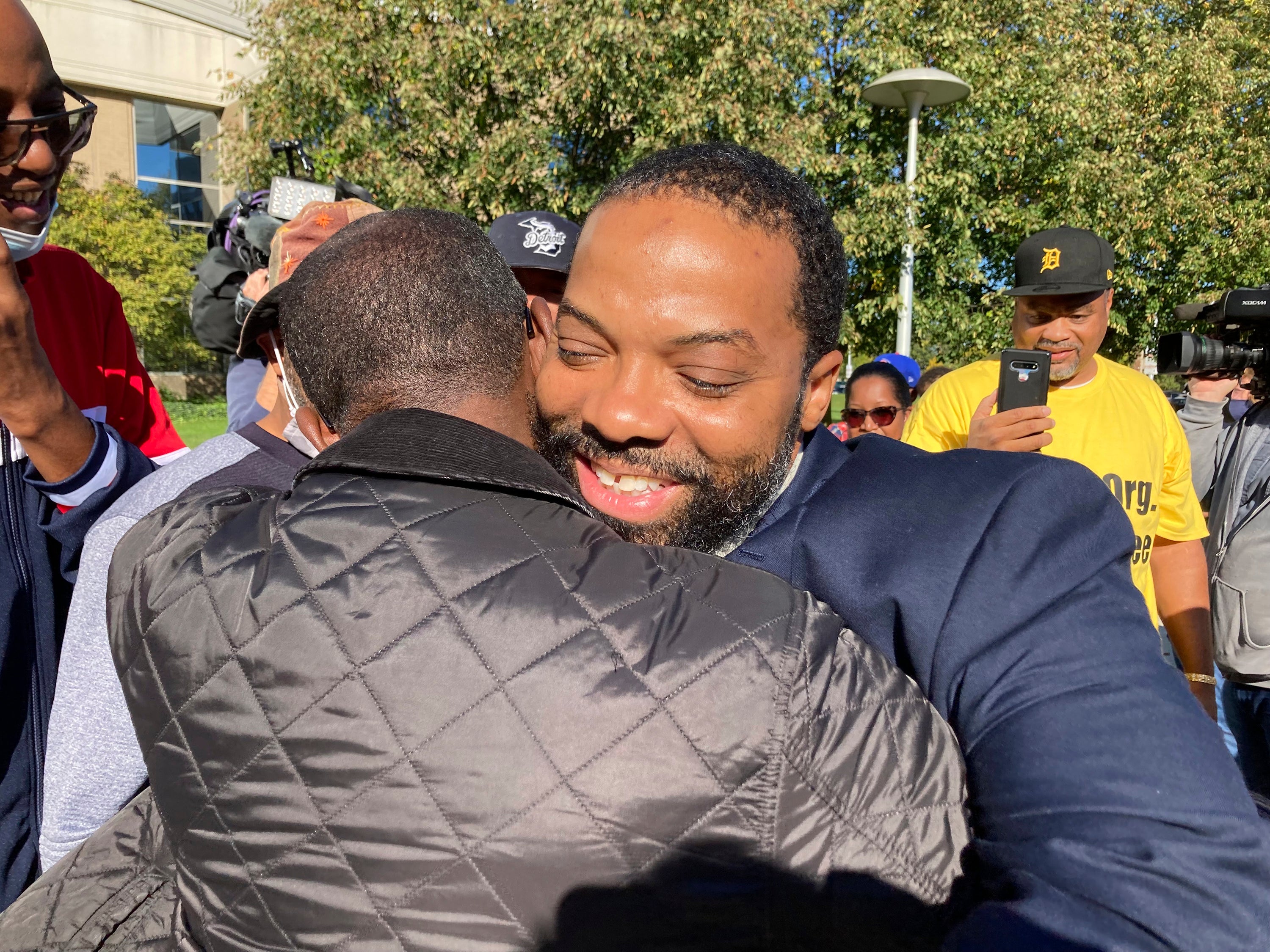 Juwan Deering gets a hug outside the courthouse in Pontiac, Michigan, on Thursday, Sept. 30, 2021, after murder charges were dropped in a fire that killed five children in suburban Detroit in 2000.