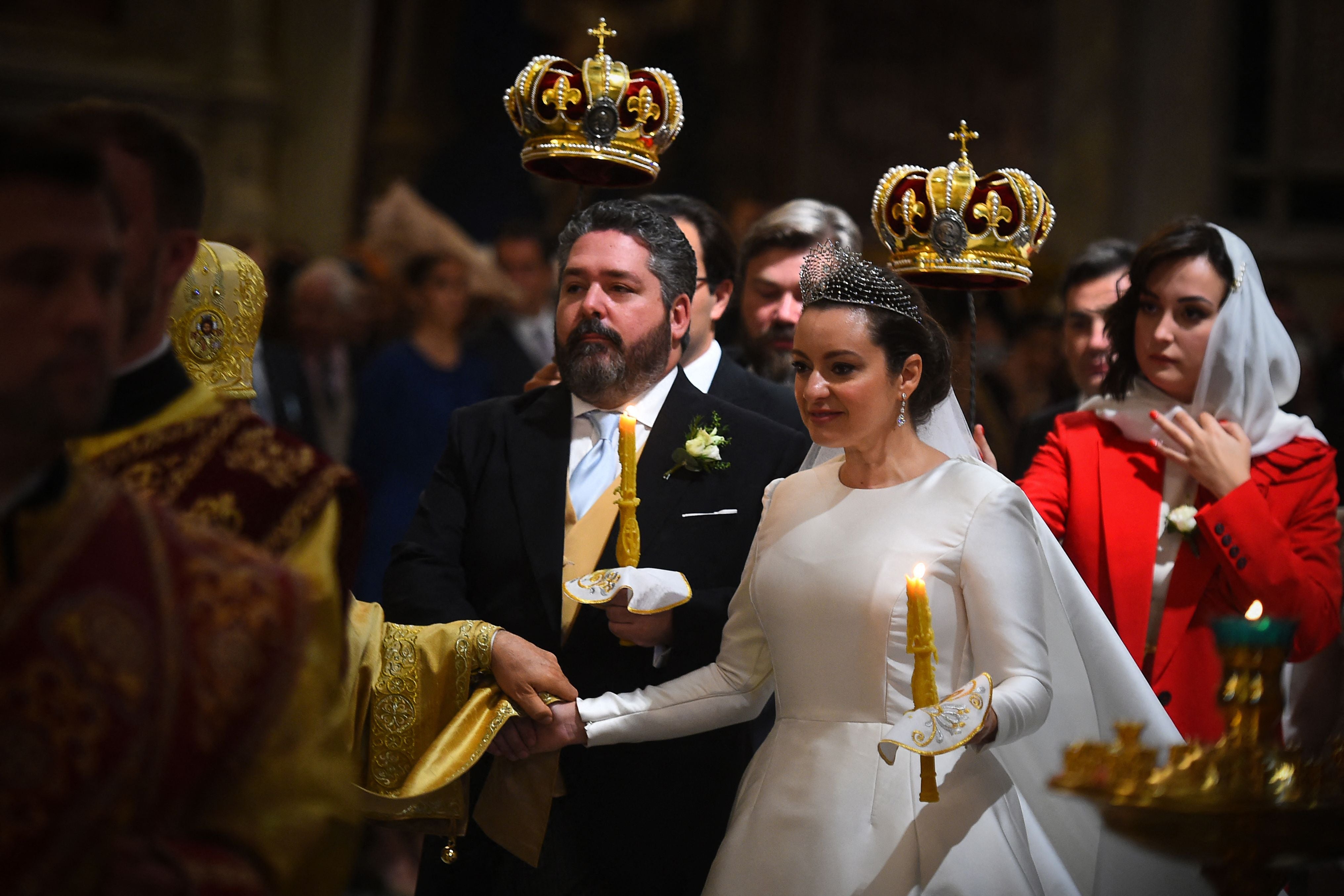 The bride wore a stiff satin long-sleeved gown with a tiara.