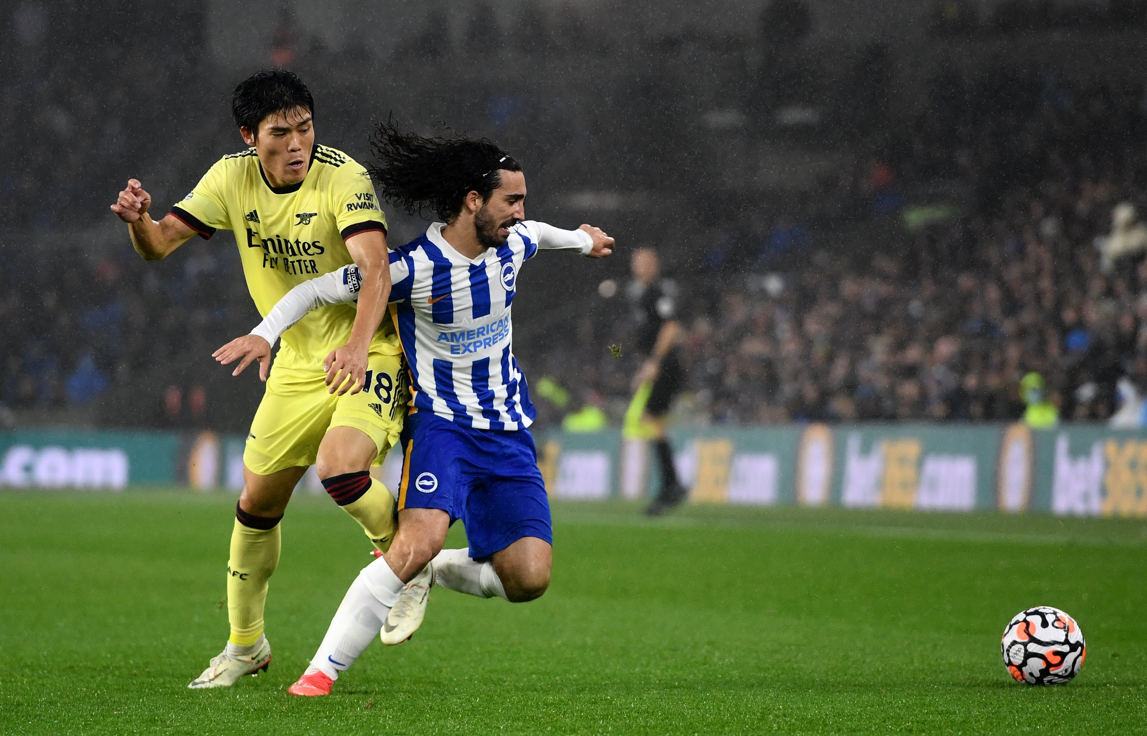 Arsenal’s Takehiro Tomiyasu, left, and Brighton’s Marc Cucurella battle for the ball (Ashley Western/PA)