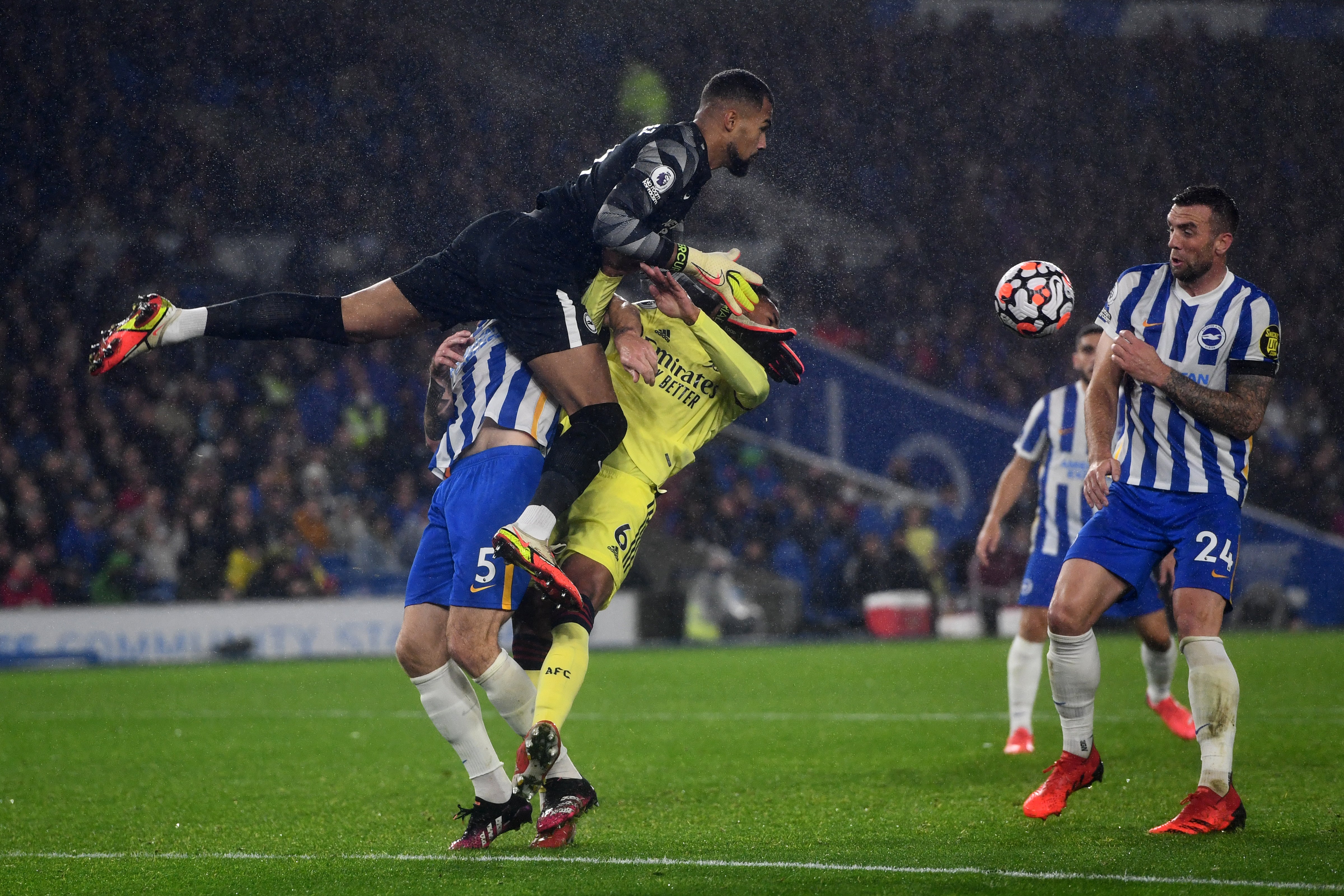 Brighton goalkeeper Robert Sanchez, left, collides with team-mate Lewis Dunk and Arsenal’s Gabriel Magalhaes (Ashley Western/PA)