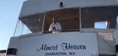 Joe Manchin leans over deck of his yacht to tell protesters why he’ll oppose funding healthcare expansion