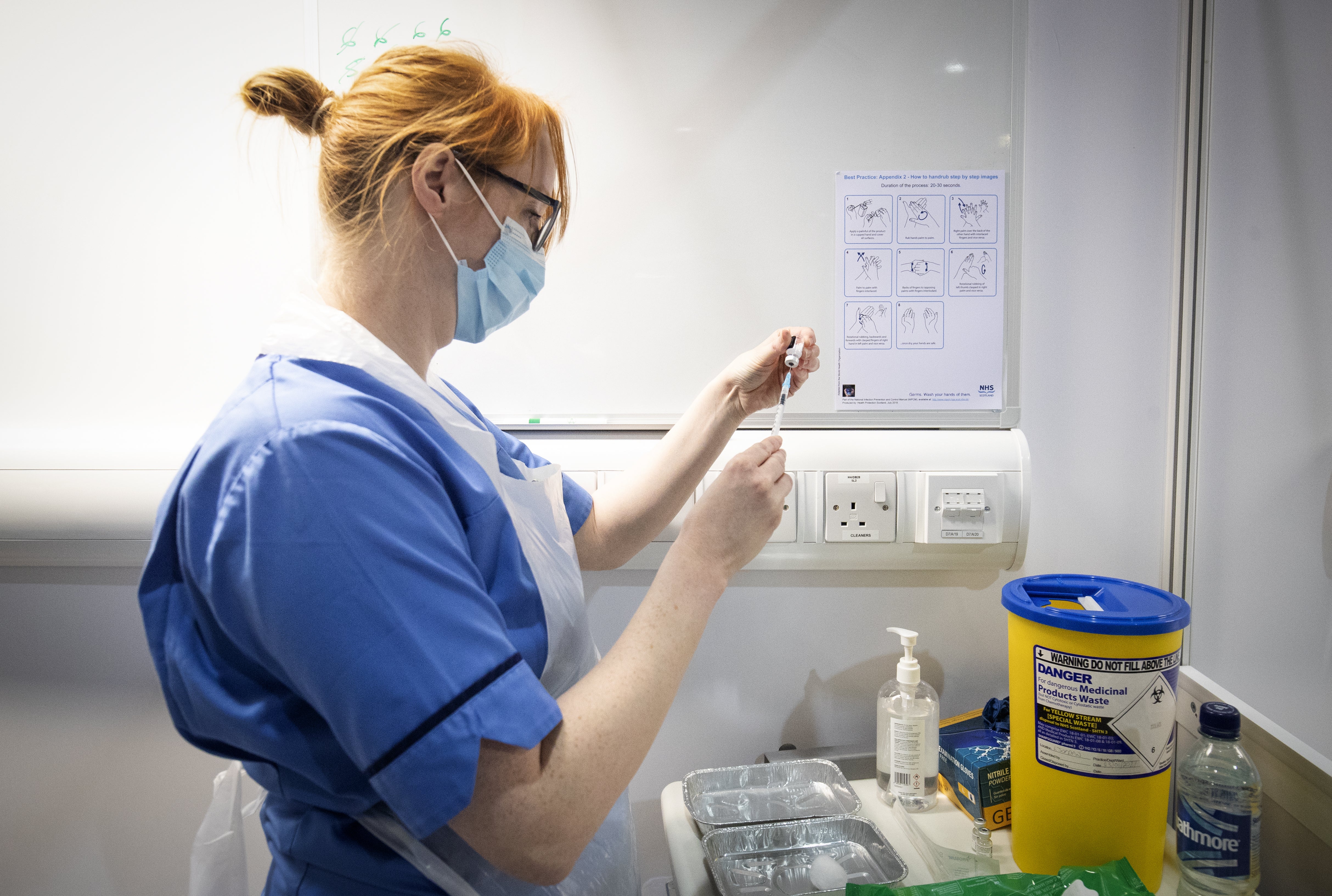 A nurse preparing a coronavirus vaccination (Jane Barlow/PA)