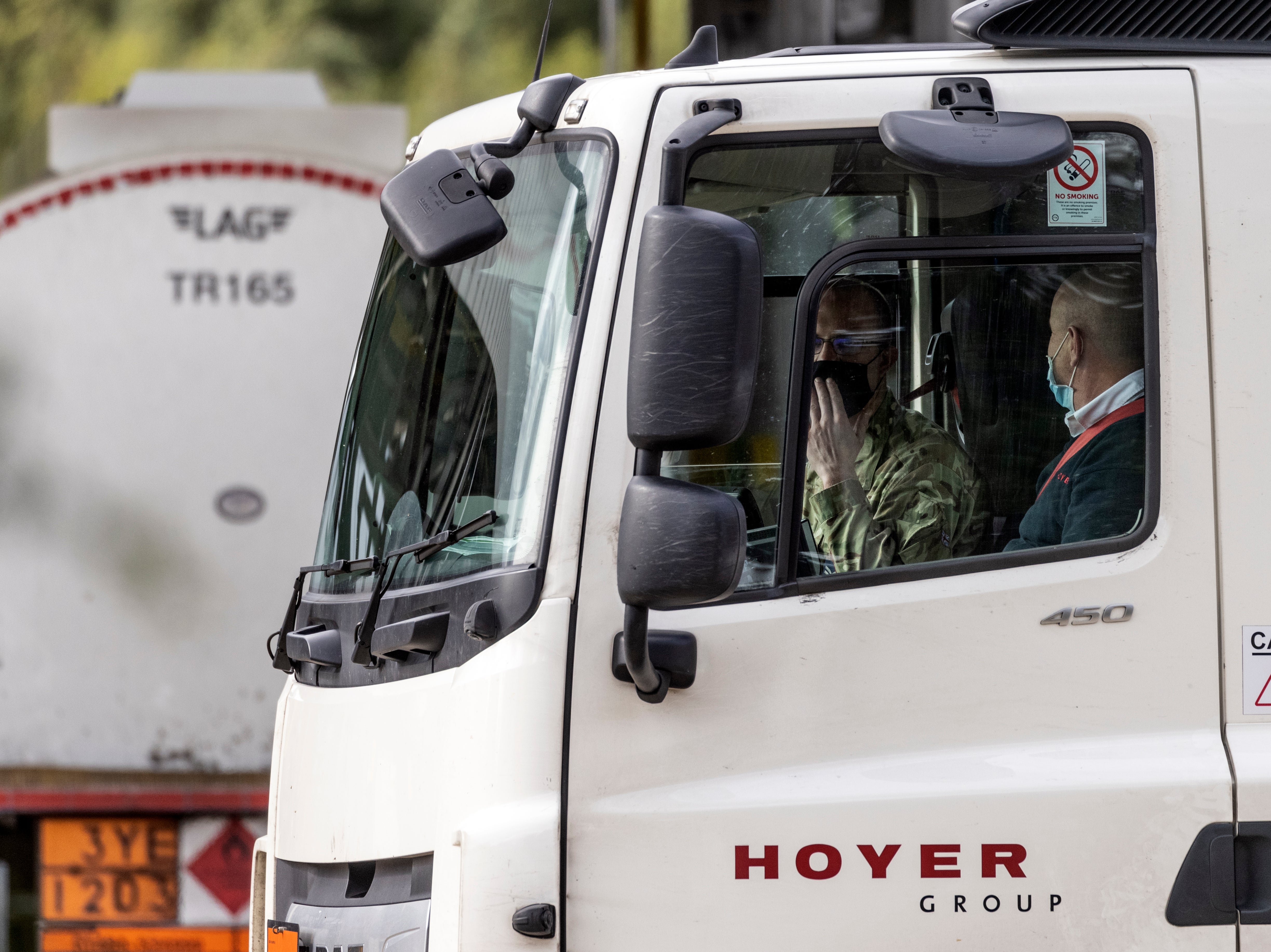 A man wearing military uniform drives a fuel tanker into the BP Plc fuel terminal on October 04, 2021 in Hemel Hempstead