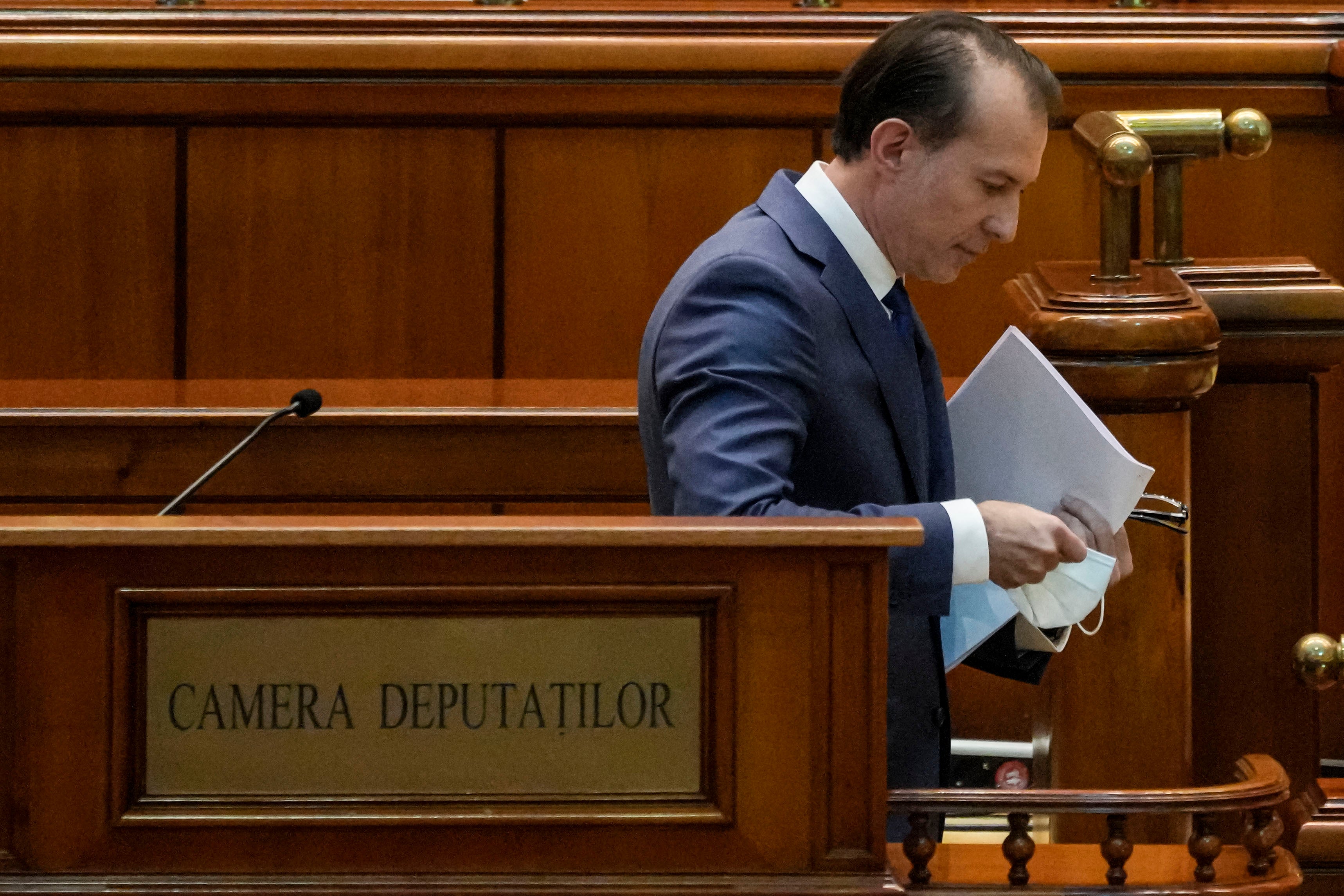 Romanian Prime Minister Florin Citu leaves after delivering his speech during a no confidence vote in Romania's parliament