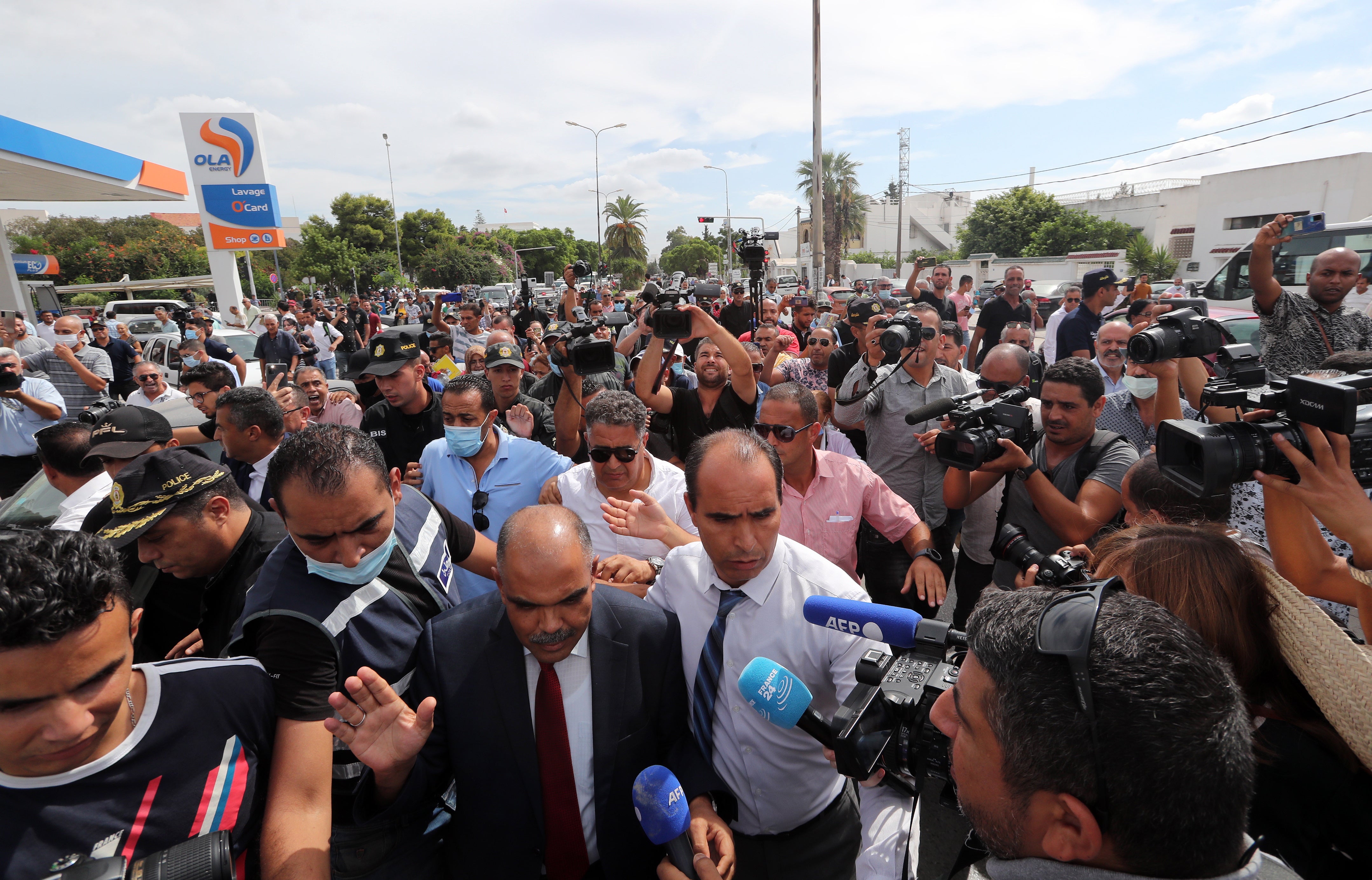 Security forces surround Mohamed Goumani, a Tunisian deputy and Ennahda member, during a rally in front of the Assembly headquarters in Tunis on 1 October