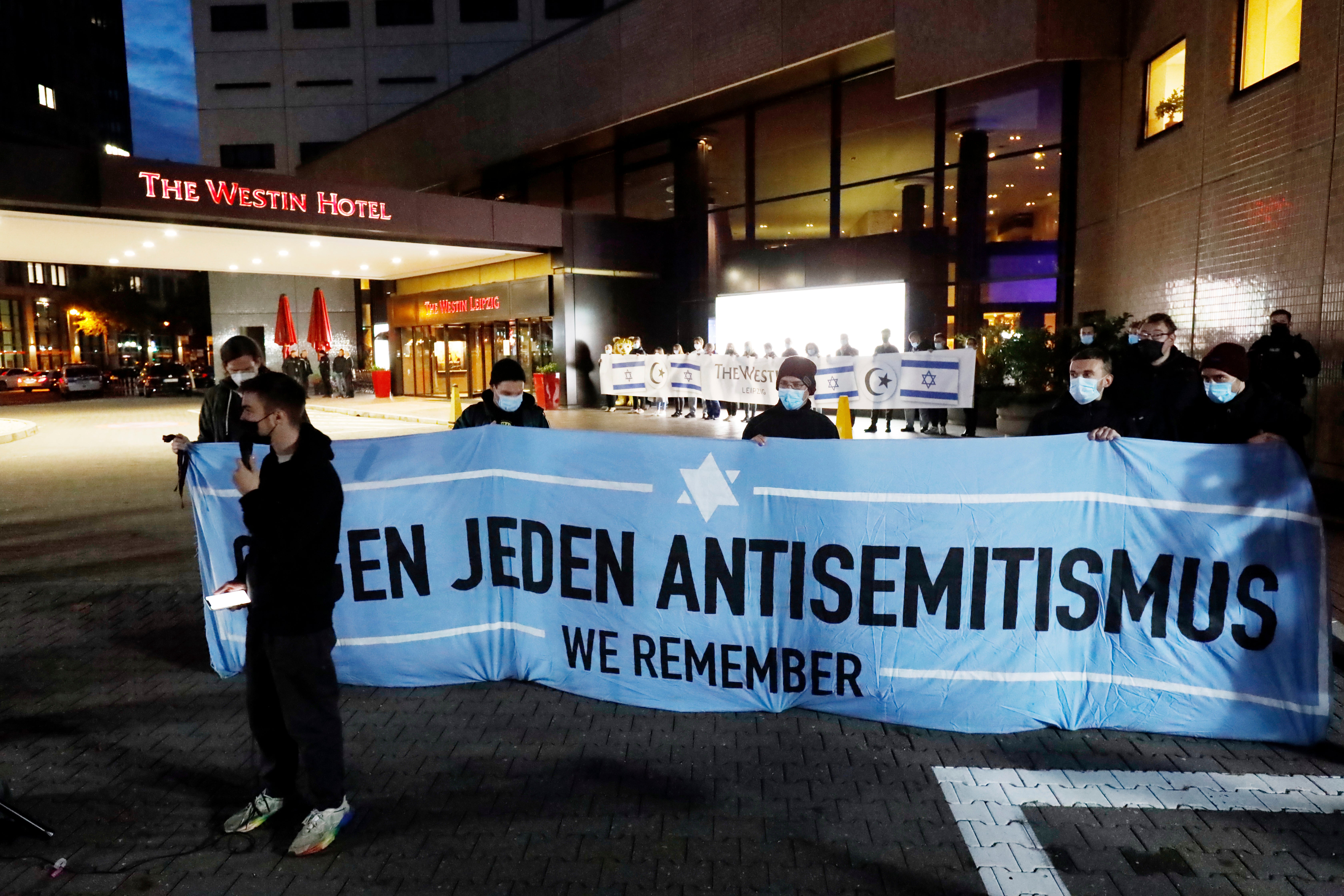 People gather in front of the Westin Hotel in Leipzig, Germany on 5 October 2021 to show their solidarity with musician Gil Ofarim