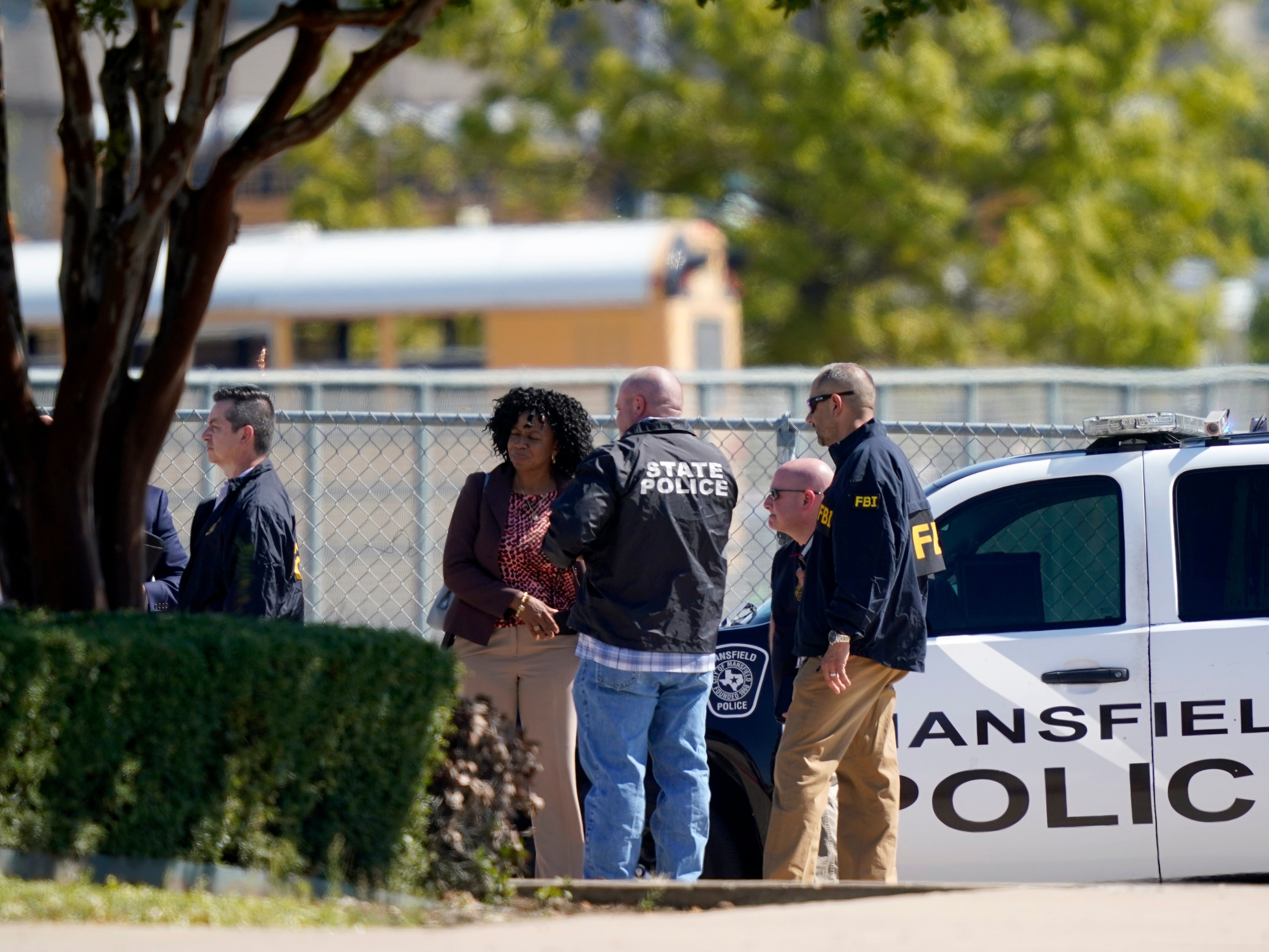 Law enforcement officers from different agencies gather in the parking lot of Timberview High School after a shooting inside the school located in south Arlington, Texas